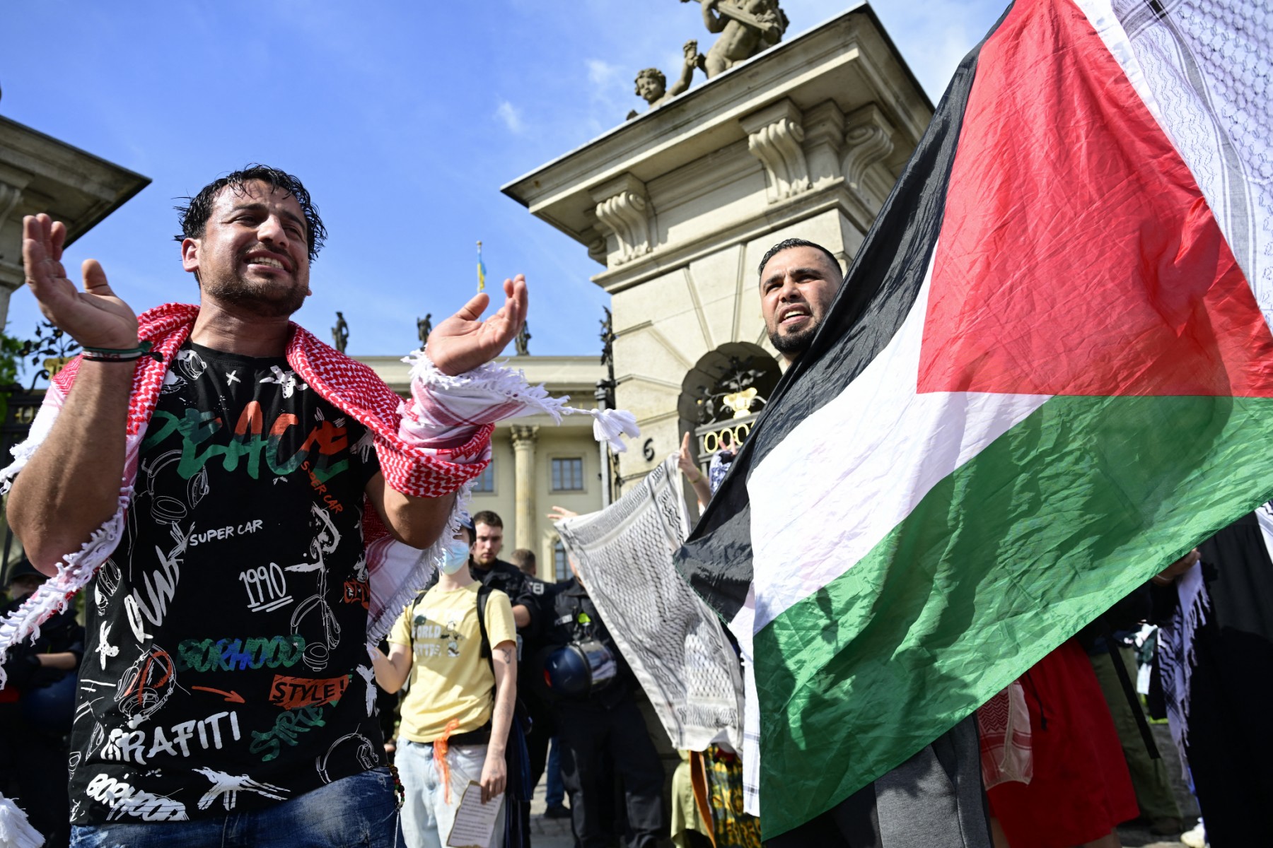 Demonstrators react and display the Palestinian flag as people staged a pro-Gaza sit-in in solidarity with the Palestinian people in front of Berlin's Humboldt University