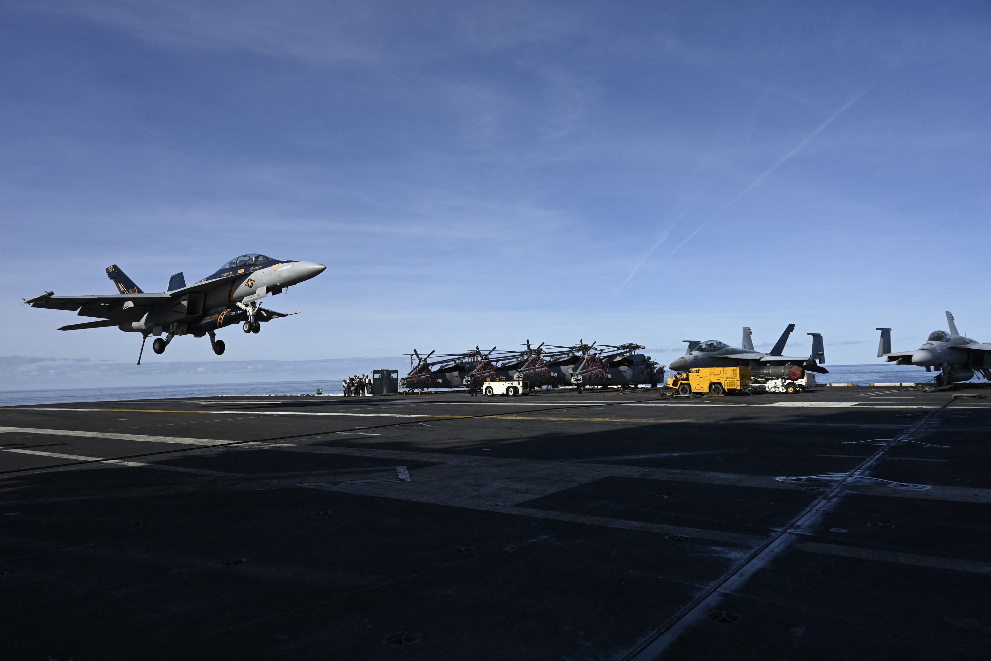 F-18E fighter jet landing on aircraft carrier USS Gerald R. Ford as it sail in the North Sea during NATO Neptune Strike 2025 exercise on September 24, 2025 in the North Sea. Denmark and Norway are participating this week in NATO's Neptune Strike 25-3 military exercises, which are taking place in the Baltic Sea and North Sea and involve the US aircraft carrier Gerald Ford. (Photo by Jonathan KLEIN / AFP)