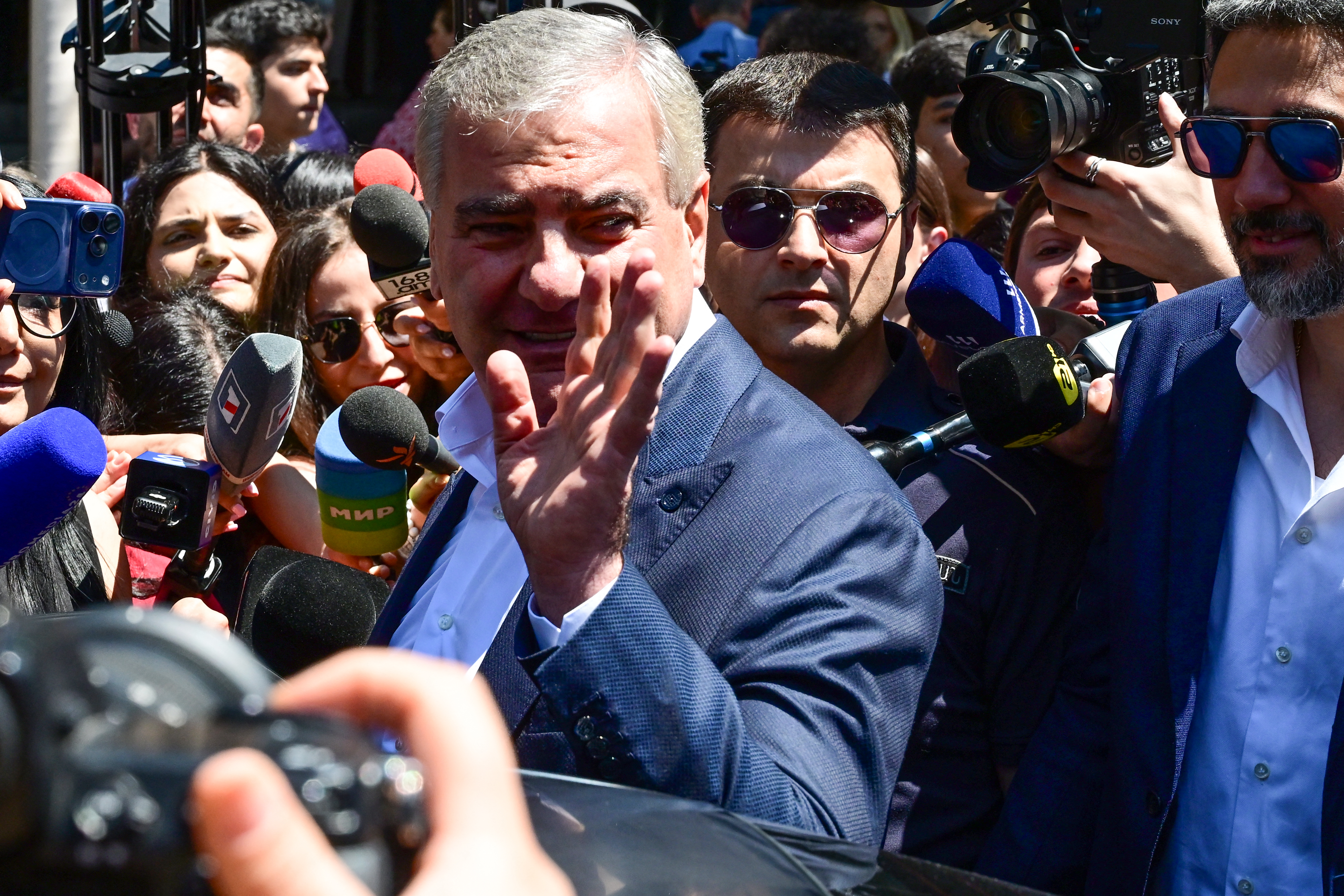 Billionaire Russian-Armenian businessman Samvel Karapetyan, leader of the Strong Armenia party, waves as he leaves a polling station after voting in Armenia's parliamentary election in Yerevan on June 7, 2026.
