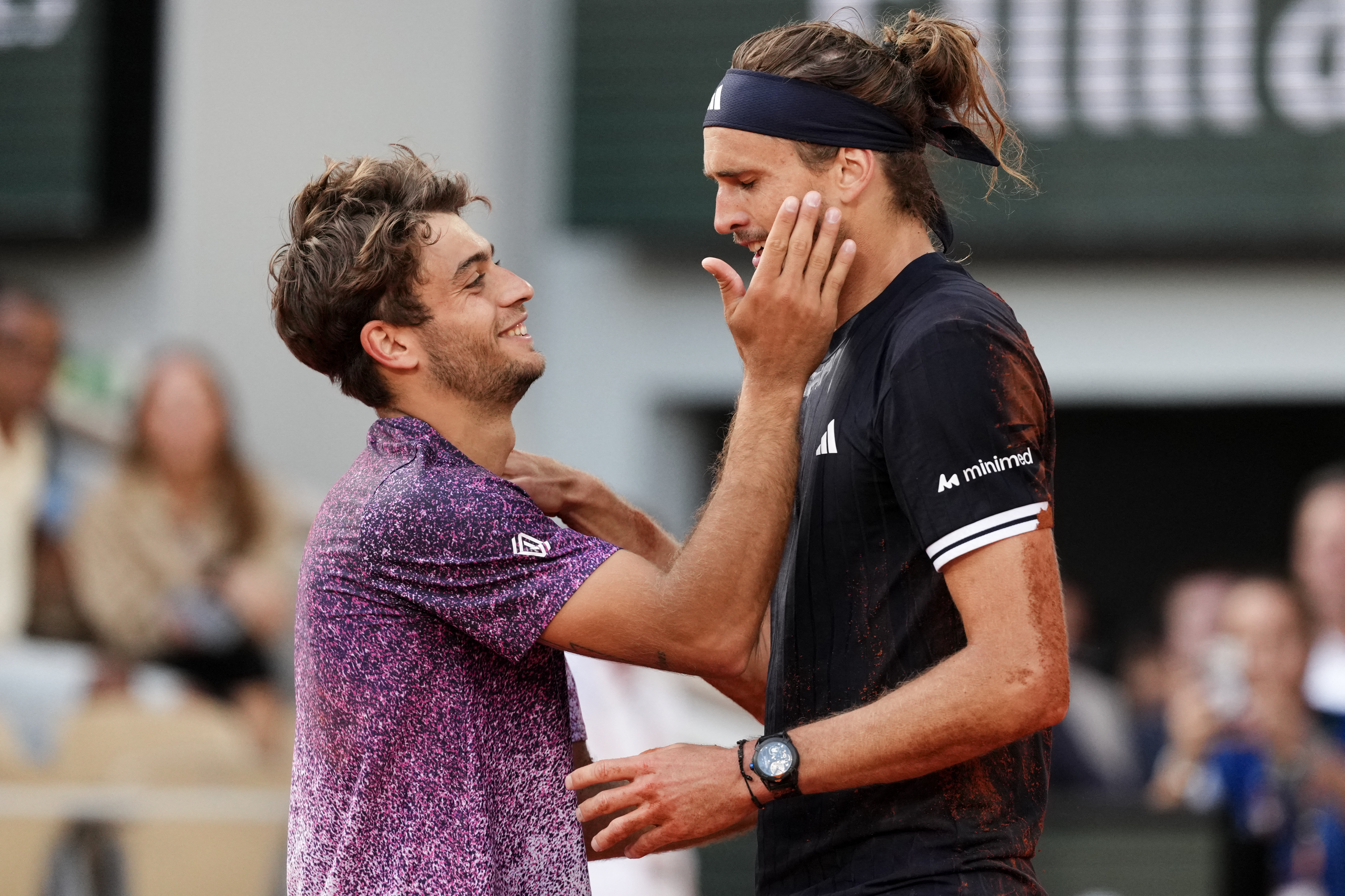 Flavio Cobolli and Alexander Zverev embrace at the end of their five-set thriller
