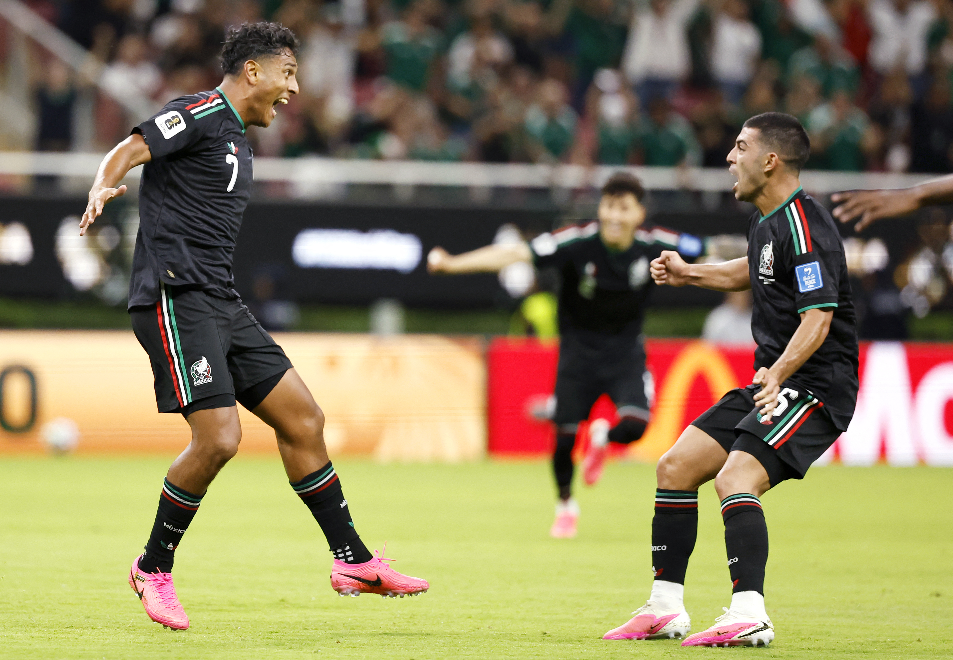 Mexico's midfielder #07 Luis Romo celebrates with teammate midfielder #06 Erik Lira scoring his team's first goal during the 2026 World Cup Group A football match between Mexico and South Korea at the Guadalajara Stadium in Zapopan on June 18, 2026. (Photo by Ulises RUIZ / AFP)