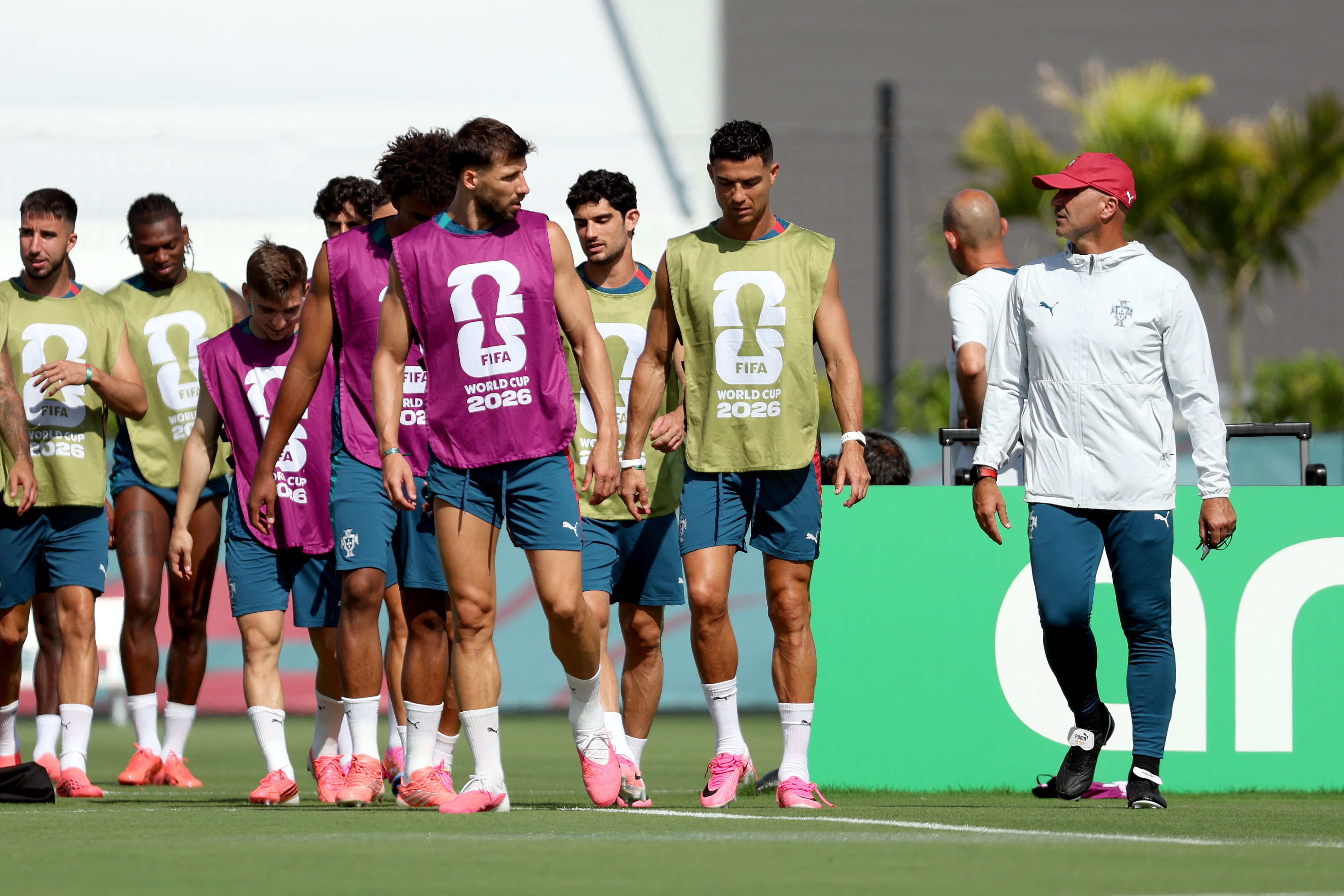 PALM BEACH, FLORIDA - JUNE 22: Ruben Dias #3, Cristiano Ronaldo #7 of Portugal speak with Head Coach Roberto Martinez of Portugal during the training of Portugal one day ahead of the FIFA World Cup 2026 Group K match between Portugal and Uzbekistan at Palm Beach Gardens Tennis & Pickleball Center on June 22, 2026 in Palm Beach, Florida. Leonardo Fernandez/Getty Images/AFP (Photo by Leonardo Fernandez / GETTY IMAGES NORTH AMERICA / Getty Images via AFP)