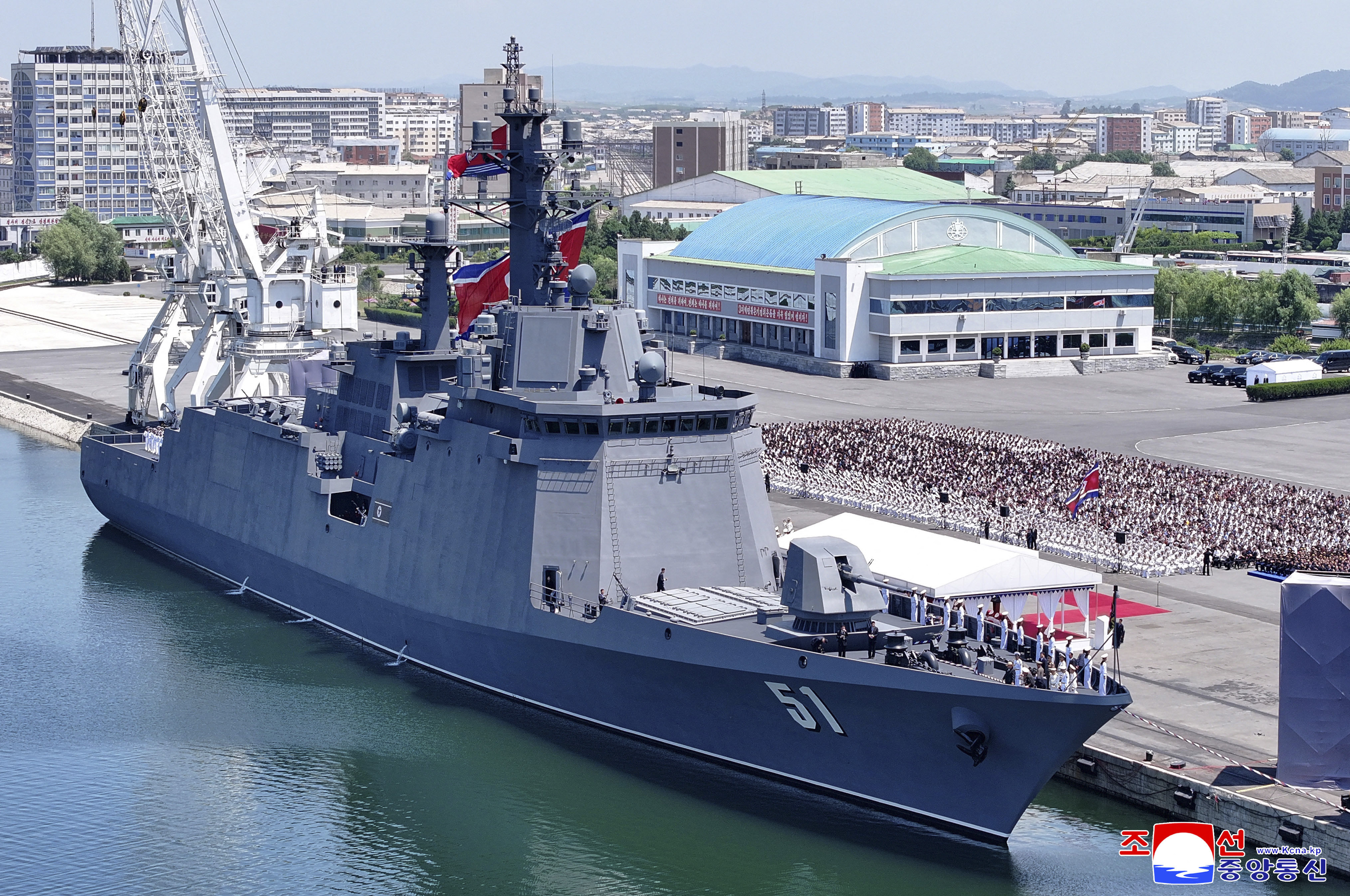 The North Korean destroyer Choe Hyon, a large grey warship, at a commissioning ceremony at a port.