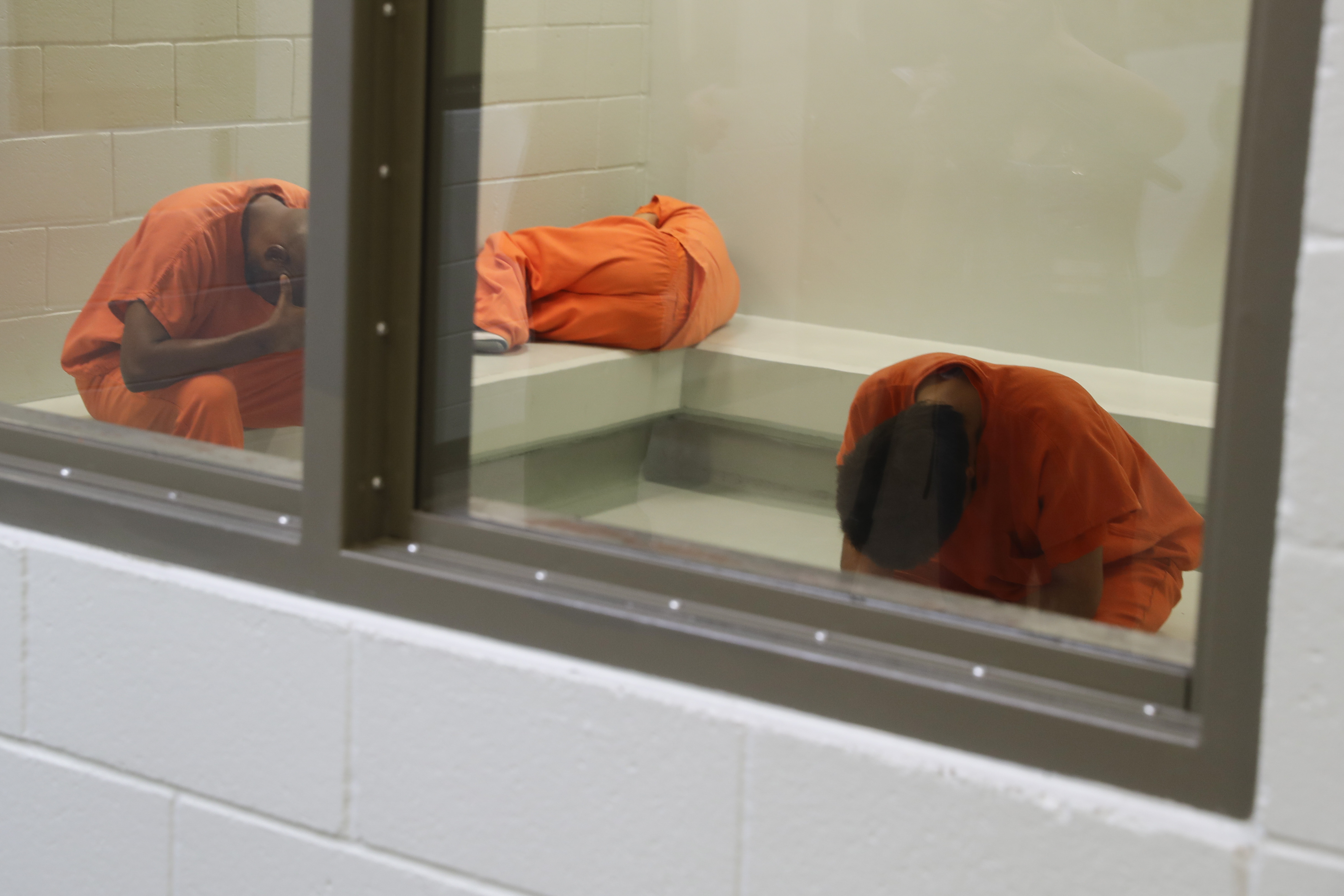 In this Wednesday, Aug. 28, 2019, photo shows detainees waiting to be processed at the Adelanto ICE Processing Center in Adelanto, Calif. The facility is a privately operated immigration detention center run by the GEO Group, which can house up to about 1900 total immigrant detainees, both male and female.