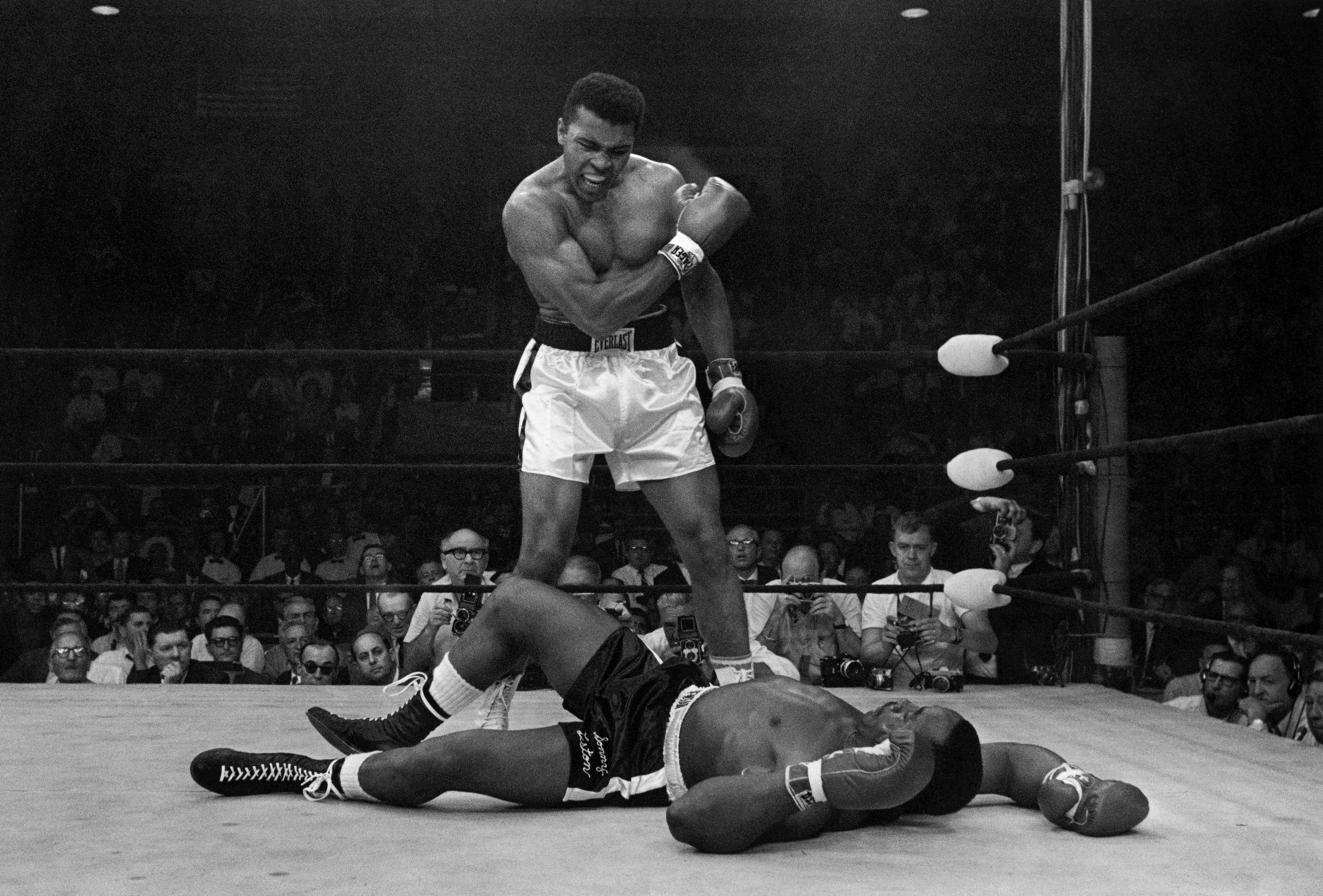 Heavyweight champion Muhammad Ali stands over fallen challenger Sonny Liston.