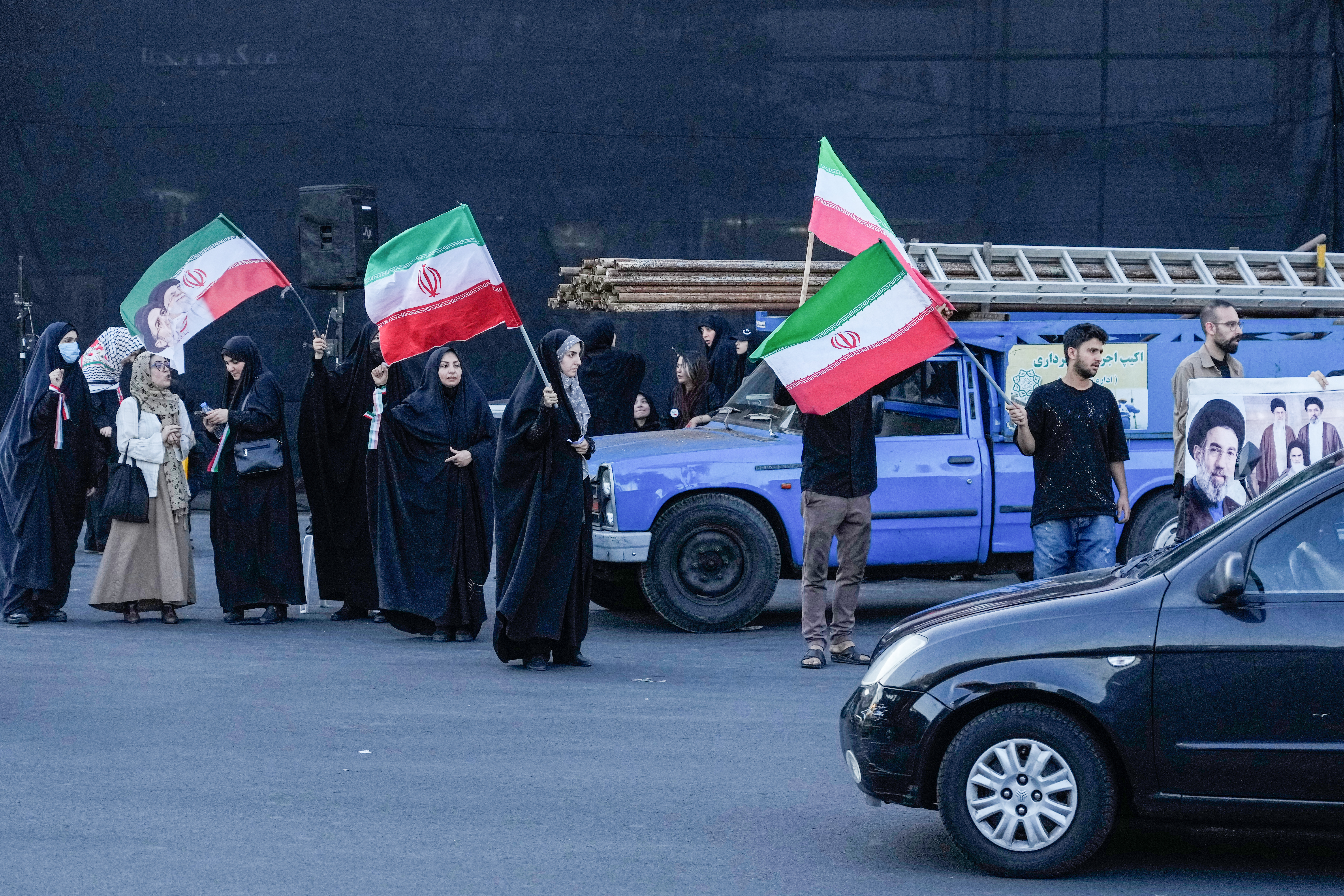 A few demonstrators wave Iranian flags.