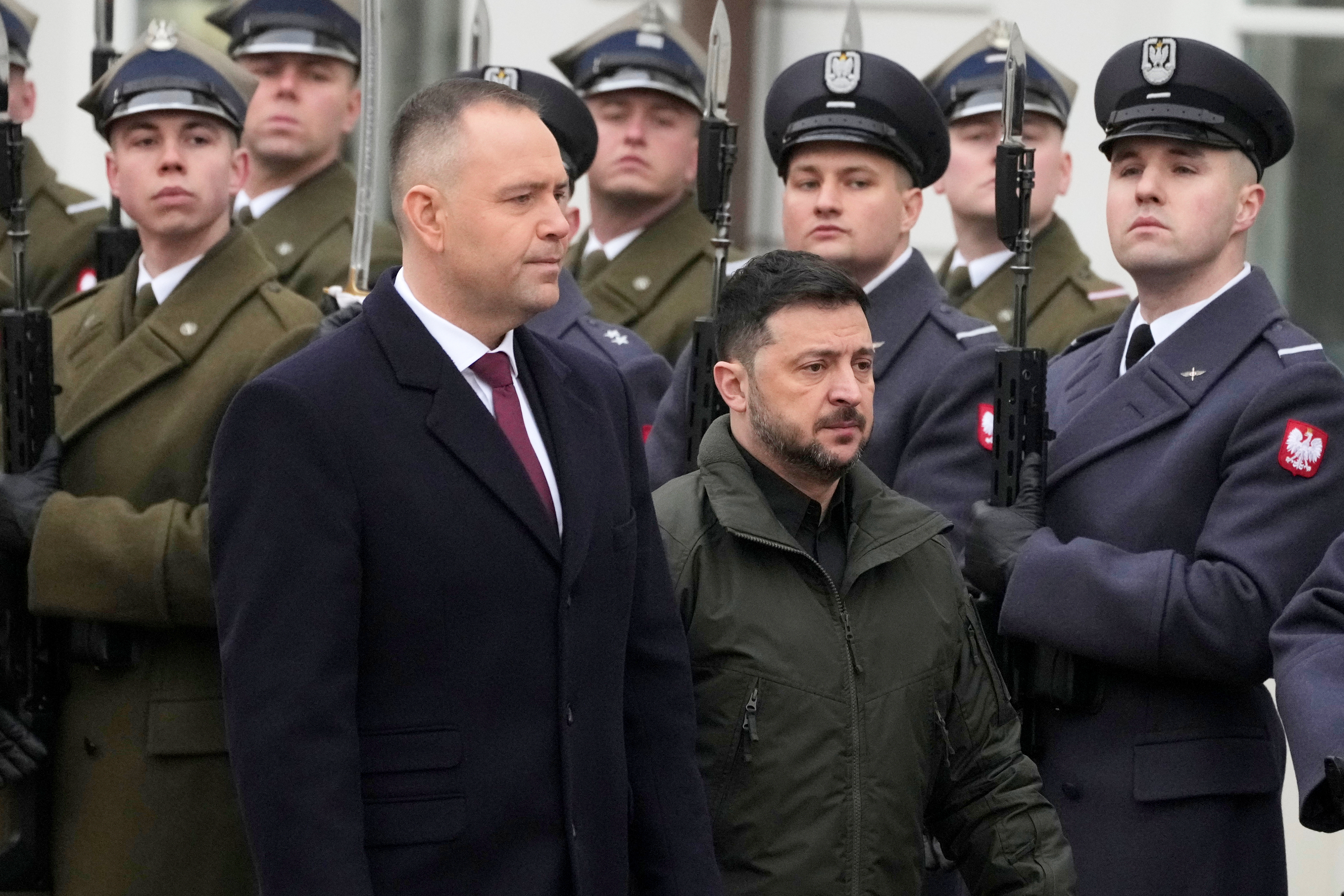 Polish President Karol Nawrocki, left, and Ukrainian President Volodymyr Zelenskyy attend an official welcome ceremony.