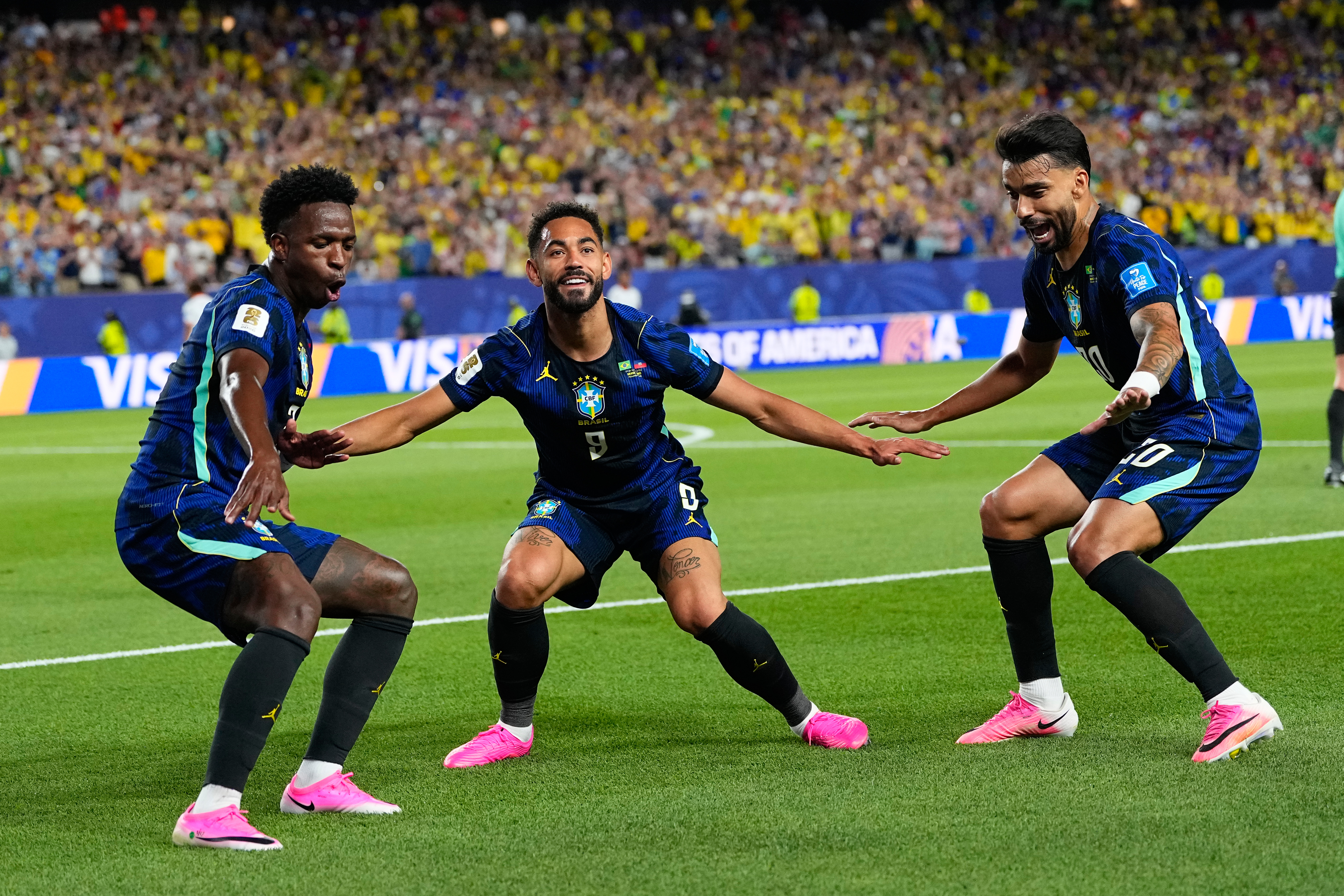 Brazil's Matheus Cunha (9) celebrates after scoring his side's second goal with Brazil's Vinicius Junior (7) and Lucas Paqueta (20)