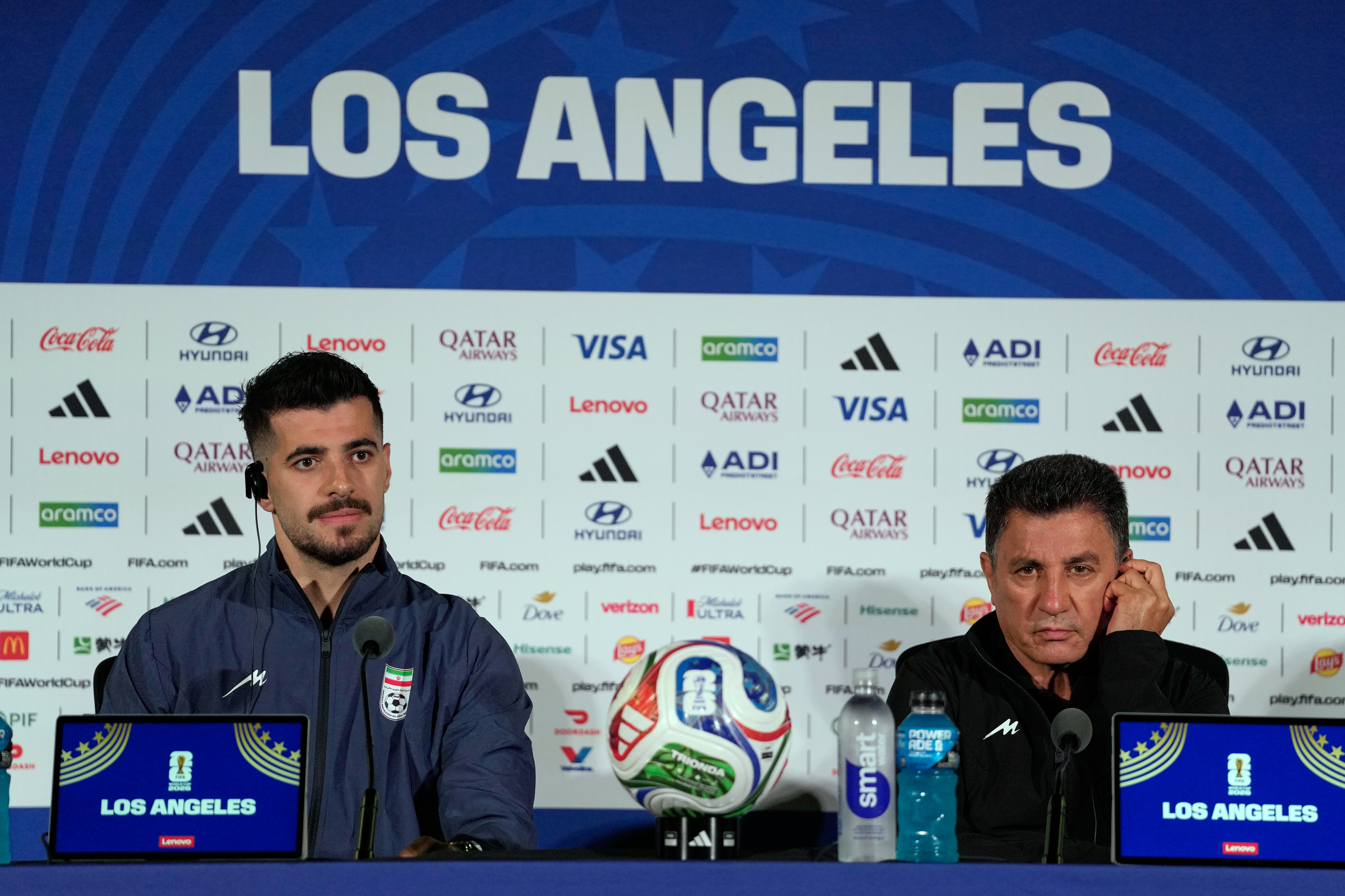 Iran head coach Amir Ghalenoei, right, and player Saeid Ezatolahi attend a press conference ahead of a FIFA World Cup match against Belgium in Inglewood, Calif., near Los Angeles, Saturday, June 20, 2026. (AP Photo/Andre Penner)
