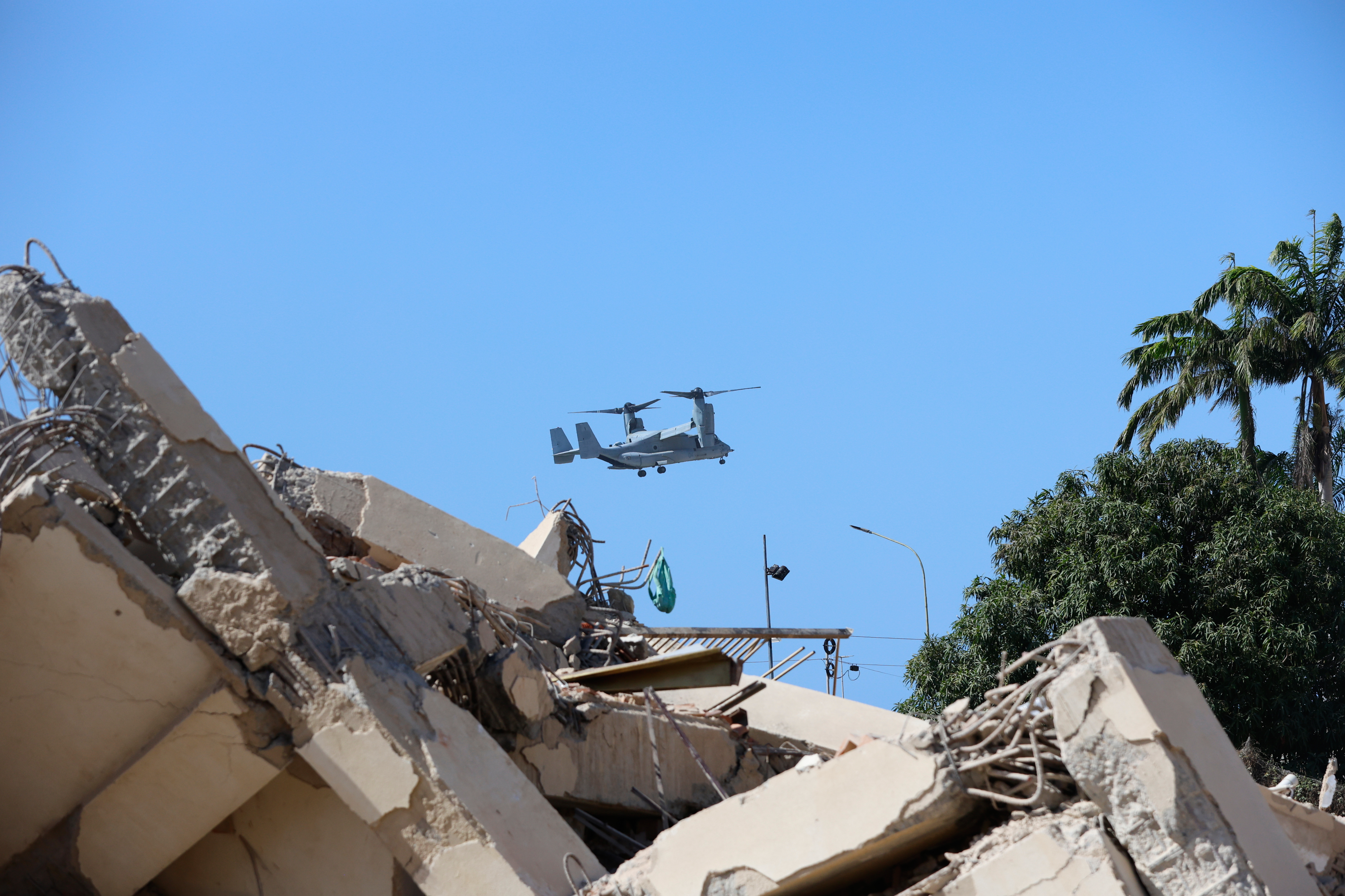 A U.S. military aircraft overflies an area struck by earthquakes in La Guaira, Venezuela, Saturday, June 27, 2026. (AP Photo/Pedro Mattey)