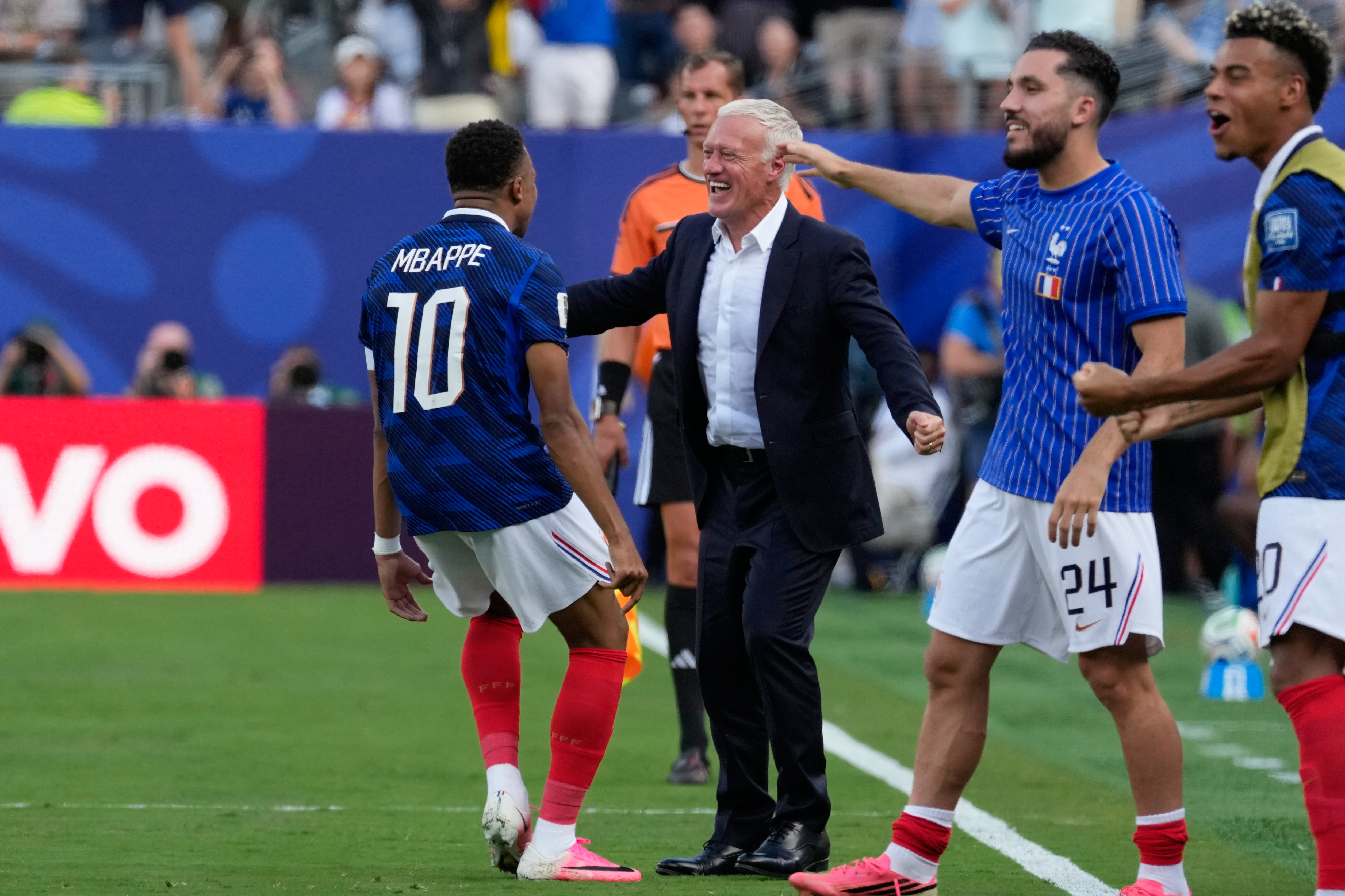 France's Kylian Mbappe, left, celebrates with his coach Didier Deschamps after scoring his side's opening goal during the World Cup round of 32 soccer match between France and Sweden in East Rutherford, N.J., near New York, Tuesday, June 30, 2026. (AP Photo/Seth Wenig)