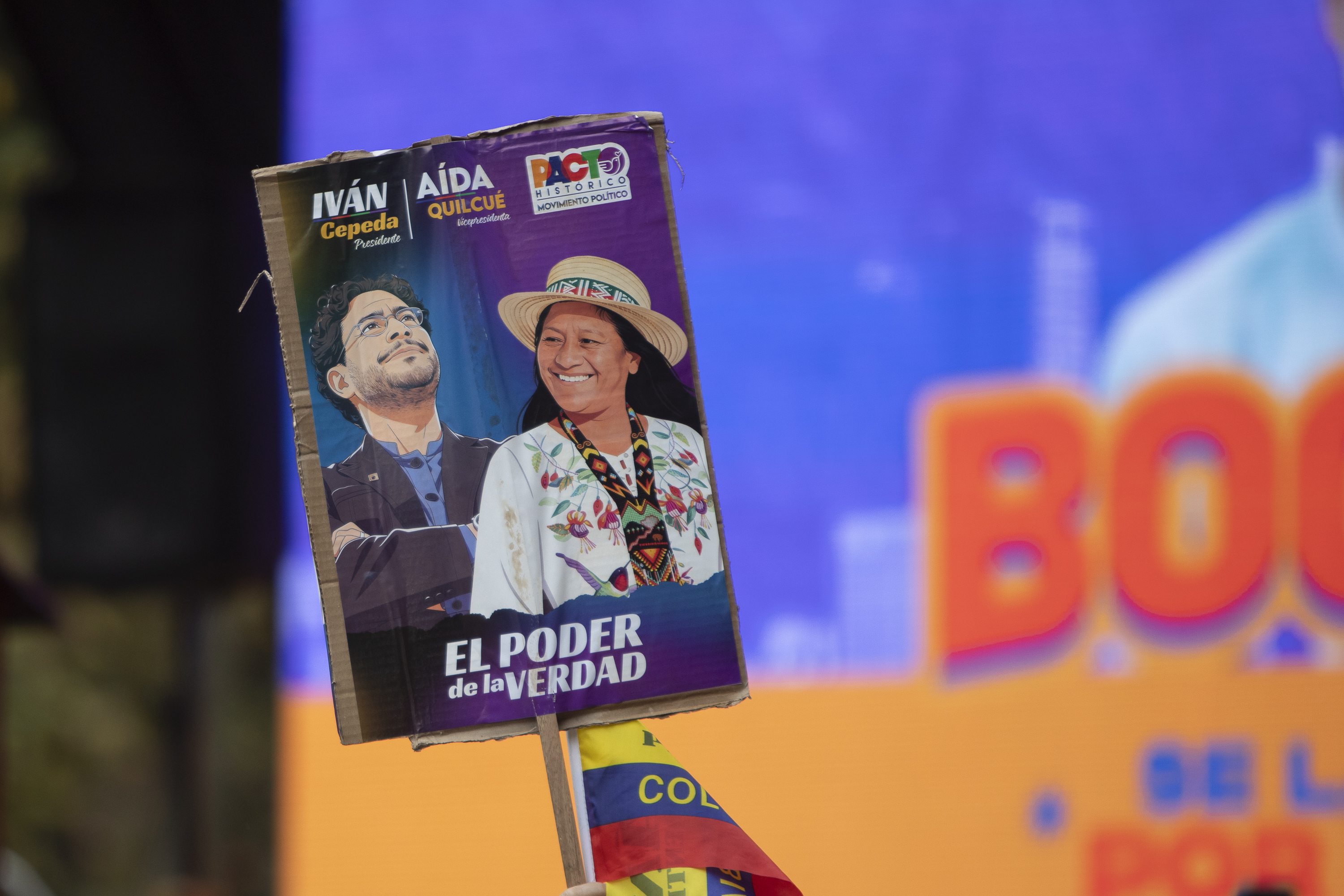 A supporter holds up a sign with Ivan Cepeda and his running mate Aida Quilcue