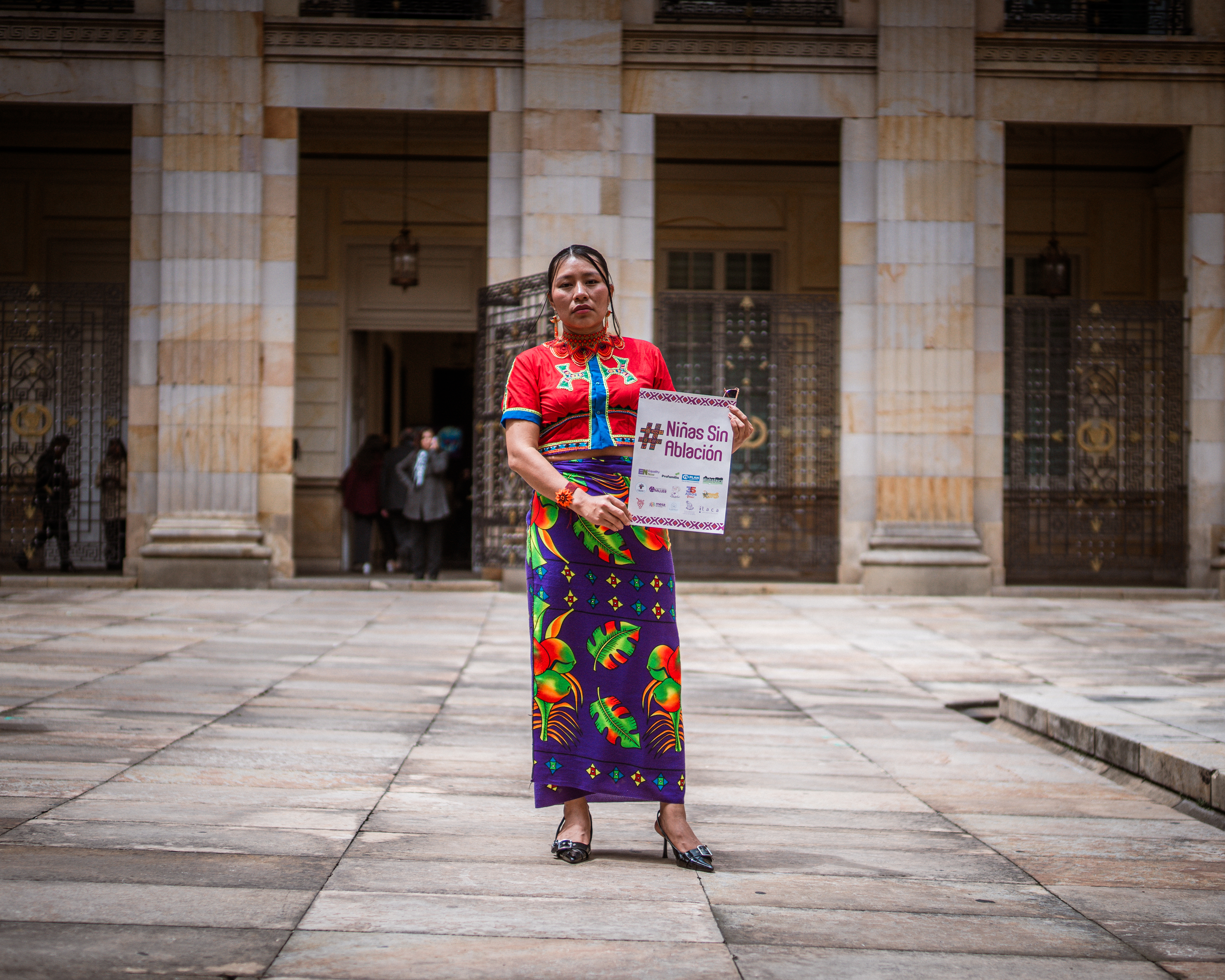 Juliana Domicó holds a placard promoting the bill Niñas sin Ablación in the Colombian congress building.