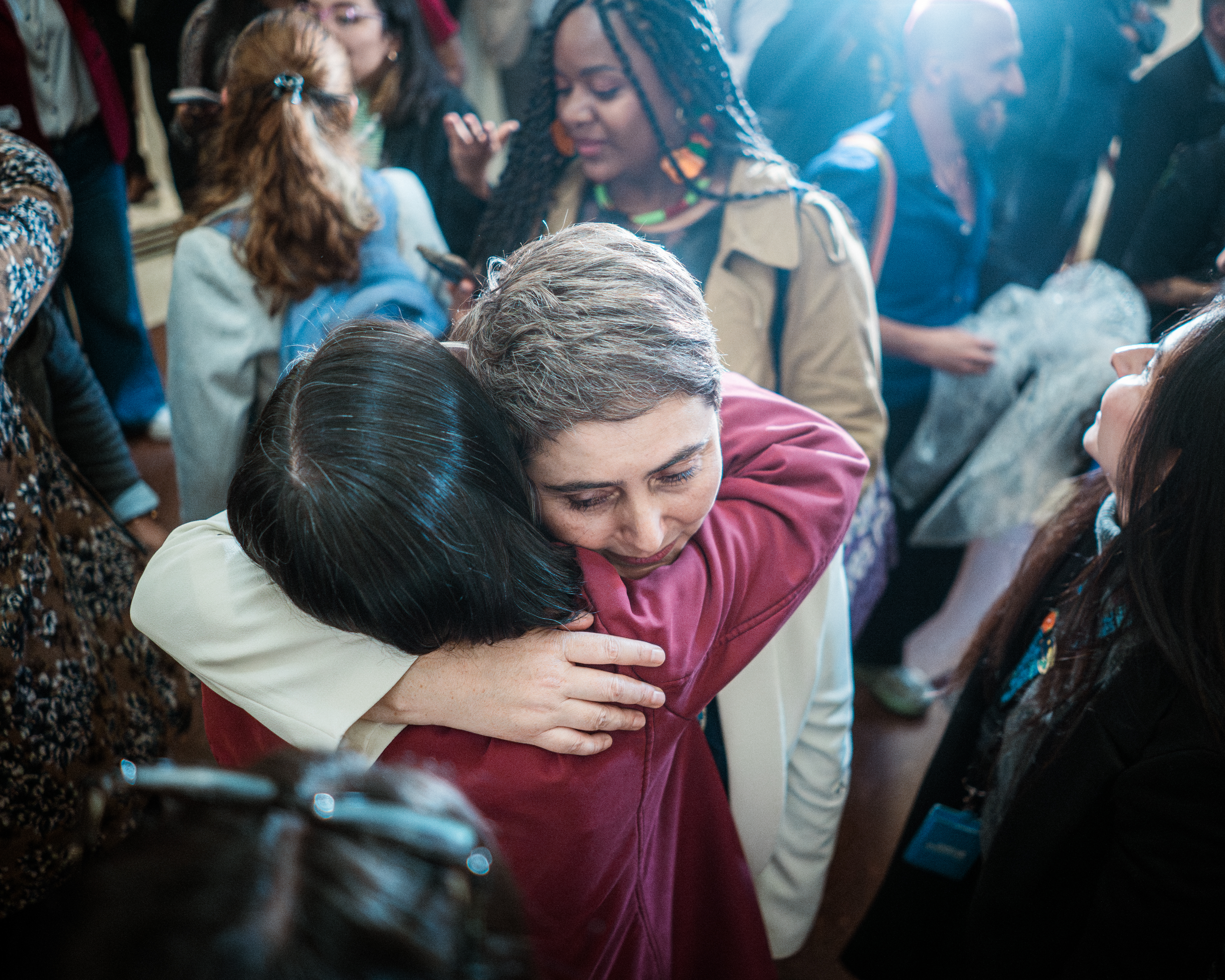 Carolina Giraldo embraces a fellow advocate of the bill after the announcement of its approval on June 10.