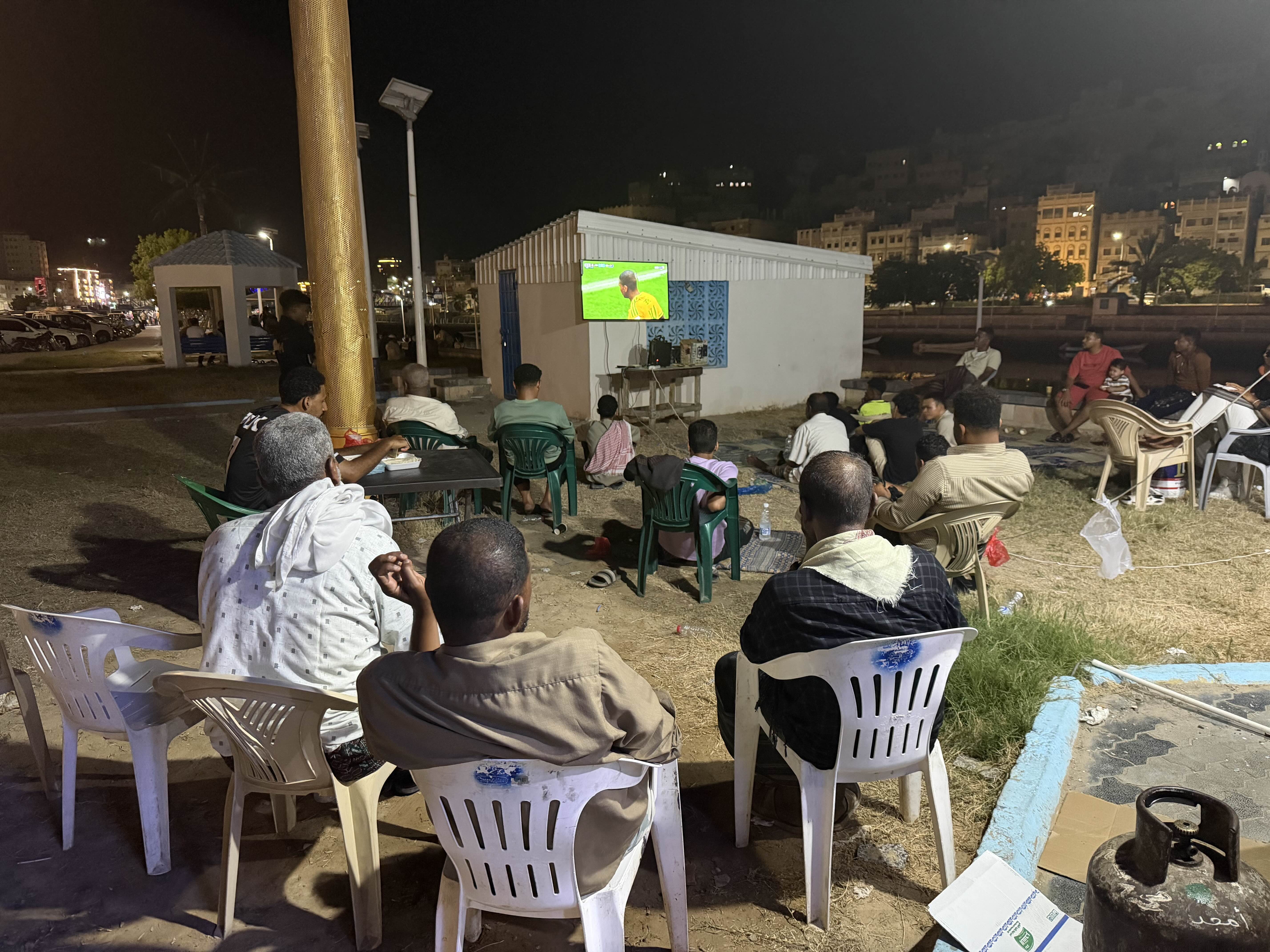 Escaping homes where power cuts, intense heat and high humidity have turned rooms into ovens, football fans in Mukalla gather at public venues and cafes to watch World Cup matches. [Saeed Al-BatatiAl Jazeera]