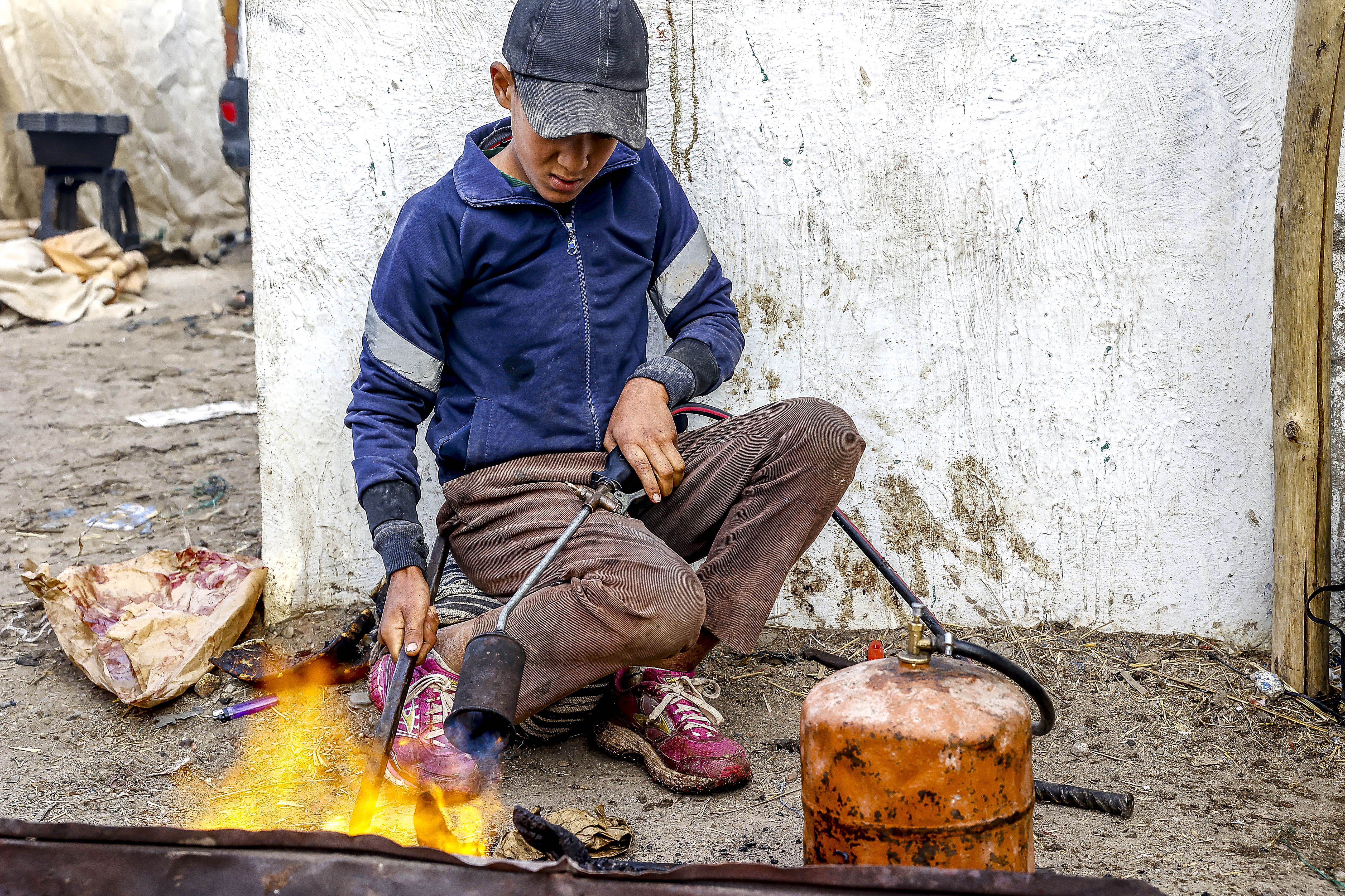 Child worker at weekly market, Had Draa, Morocco. (Photo by: Godong/Universal Images Group via Getty Images)
