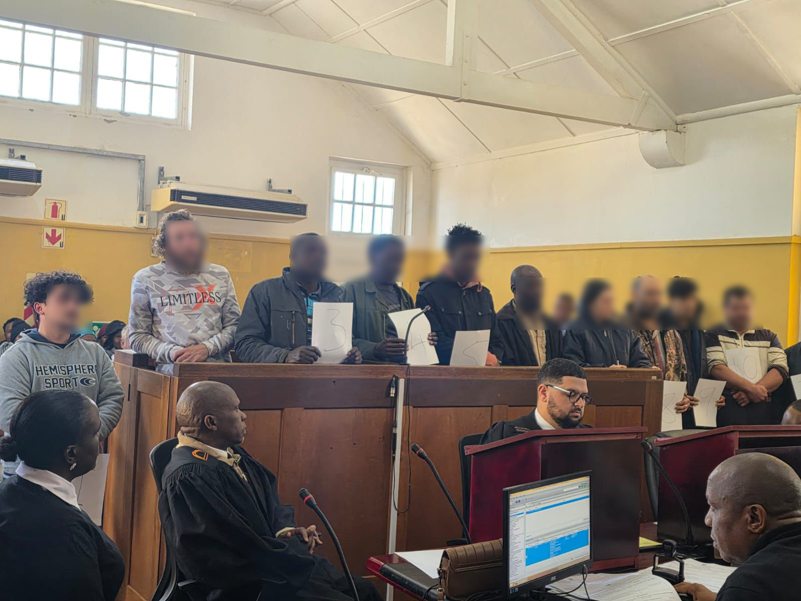 11 suspects appeared in Swartruggens Magistrate’s Court facing charges including drug manufacturing, illegal possession of hazardous materials, and violations of the Immigration Act.[Handout/SA Police Service]