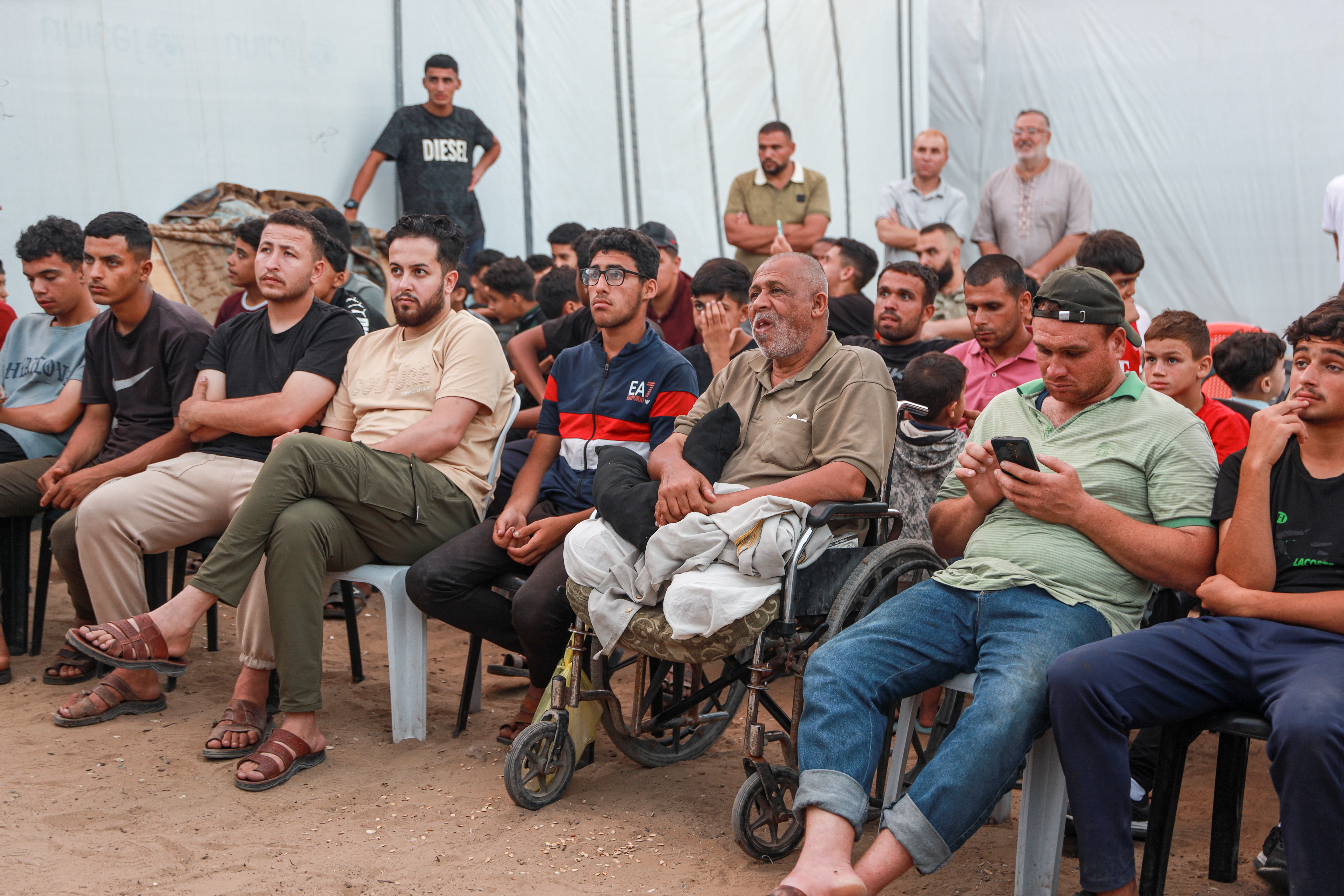 Gaza residents watch the Spain vs Saudi Arabia match in a makeshift café set up near displacement tents in Gaza City