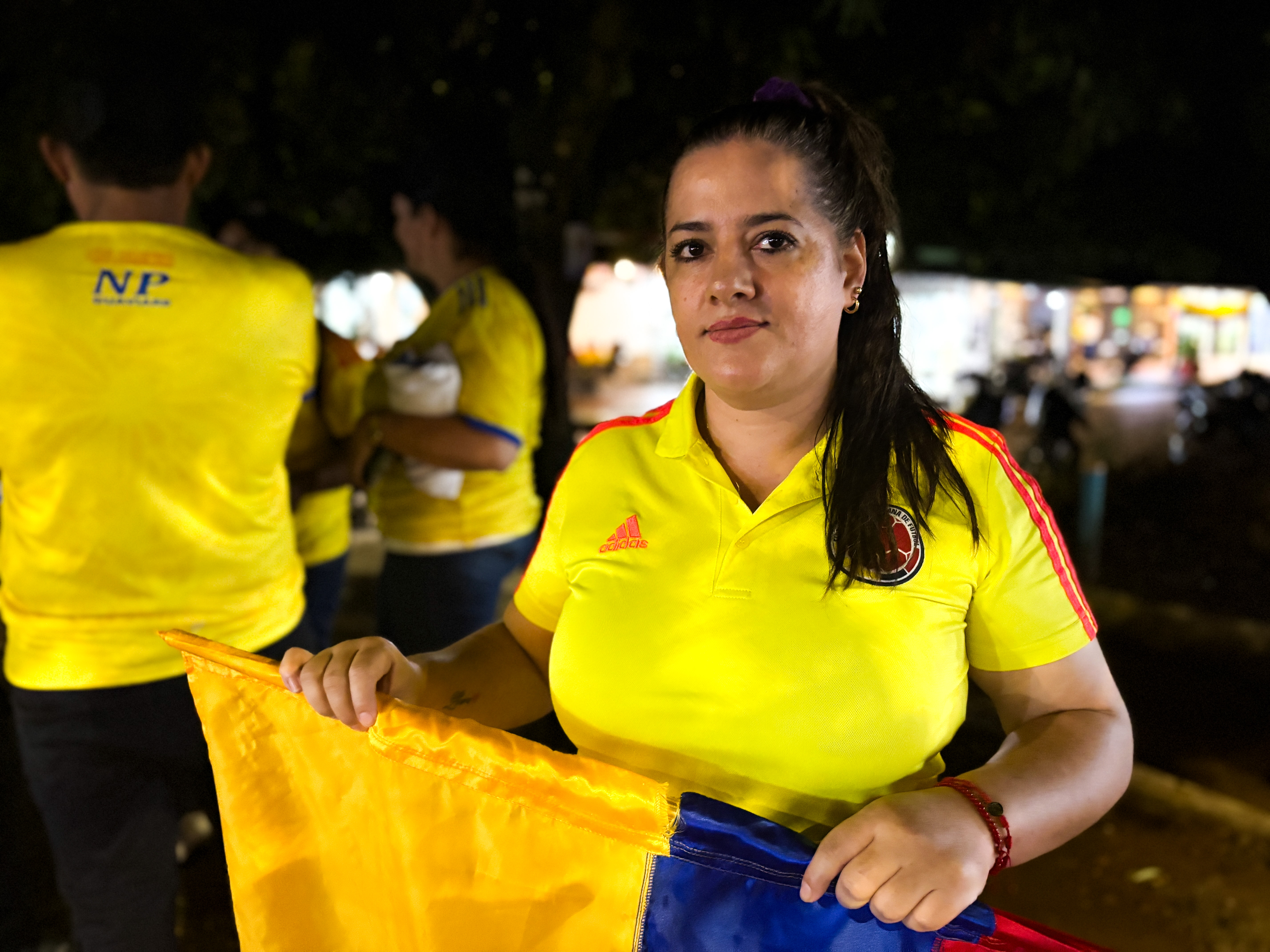 Luisa Castro holds a Colombian flag