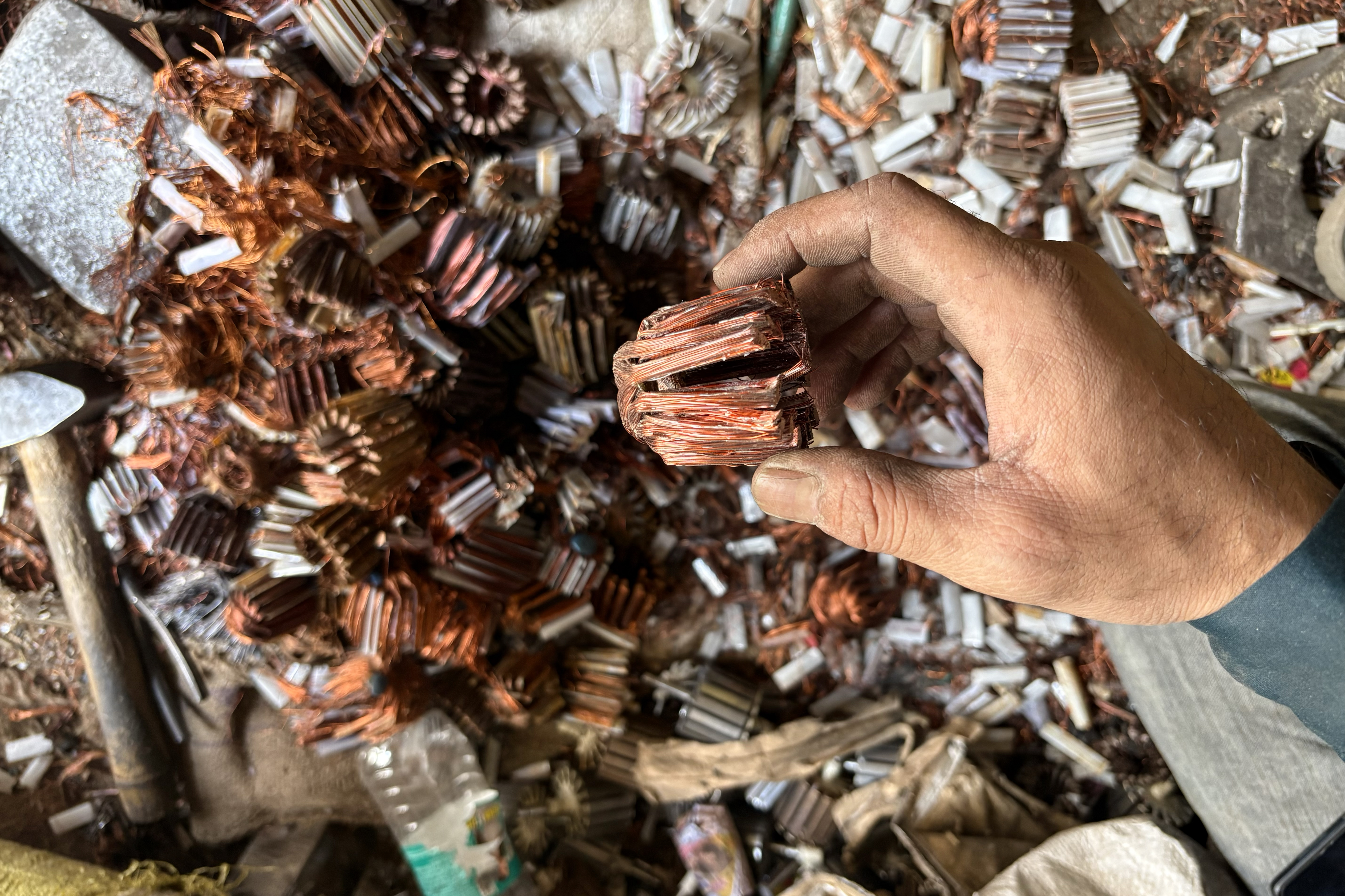 A man separates the copper wires of a water purifier.
