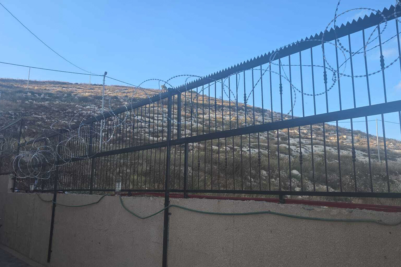 Following the attack, Sadeq Faqih was forced to fortify his dream home in Beit Imrin with heavy barbed wire and metal guards, transforming it into what he describes as a ‘real prison’ [Courtesy of the Faqih family]