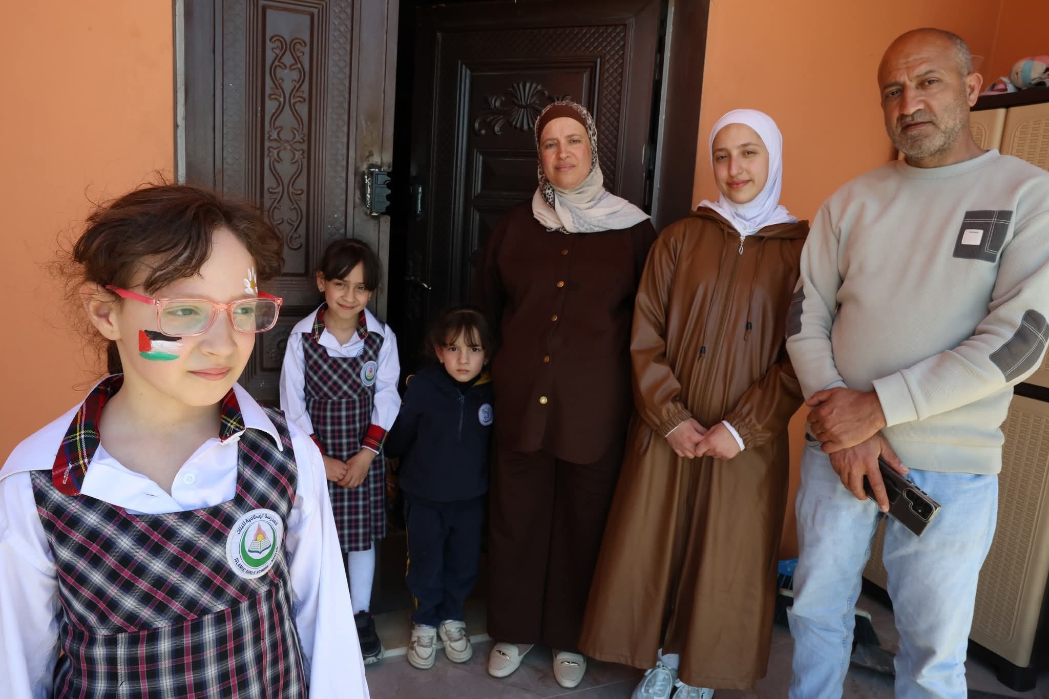 Sadeq Faqih, 41, stands with his wife Abeer and their daughters outside their home in Beit Imrin, which was targeted in a settler attack [Courtesy of the Faqih family]