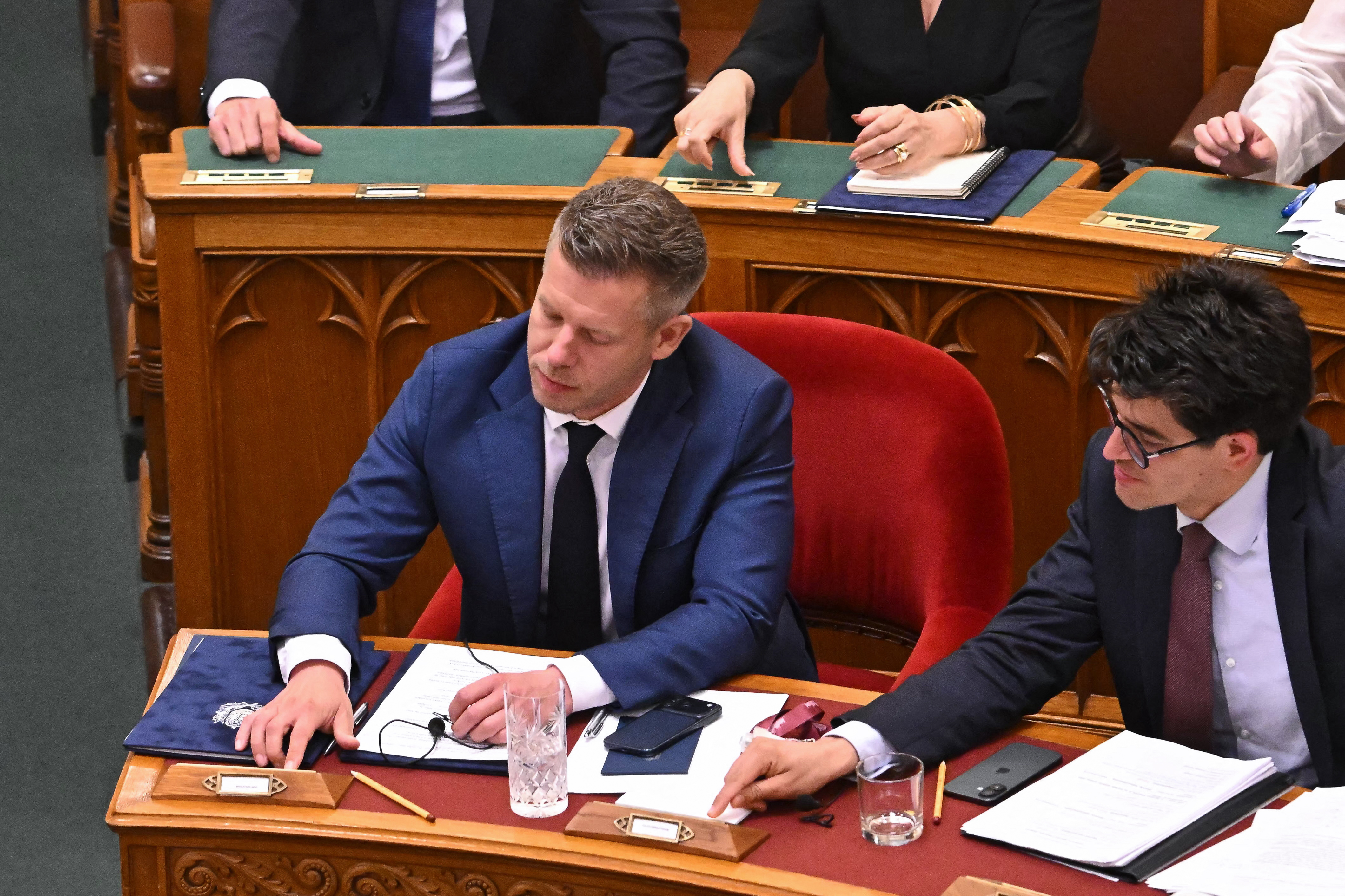 Hungary's Prime Minister Peter Magyar and Gyorgy Velkey, the parliamentary state secretary at the country's Foreign Ministry, push buttons to vote on an amendment to the constitution by introducing term-limits for prime ministers for a maximum of eight years in office, in Budapest, Hungary, June 15, 2026 [Attila Kisbenedek/AFP]