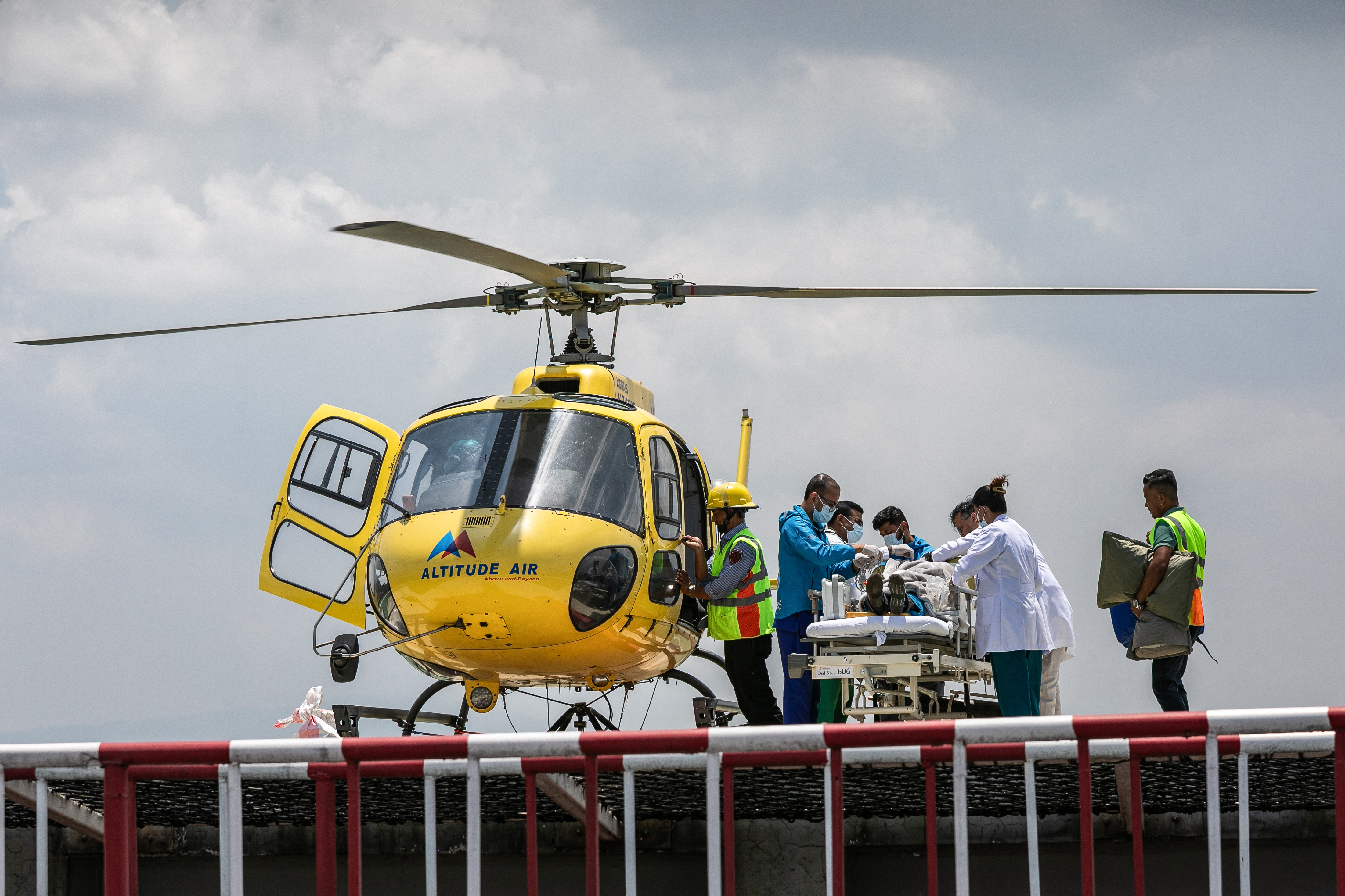 Medics and rescuers transfer mountaineer Dawa Sherpa from a helicopter upon his arrival at a hospital in Kathmandu