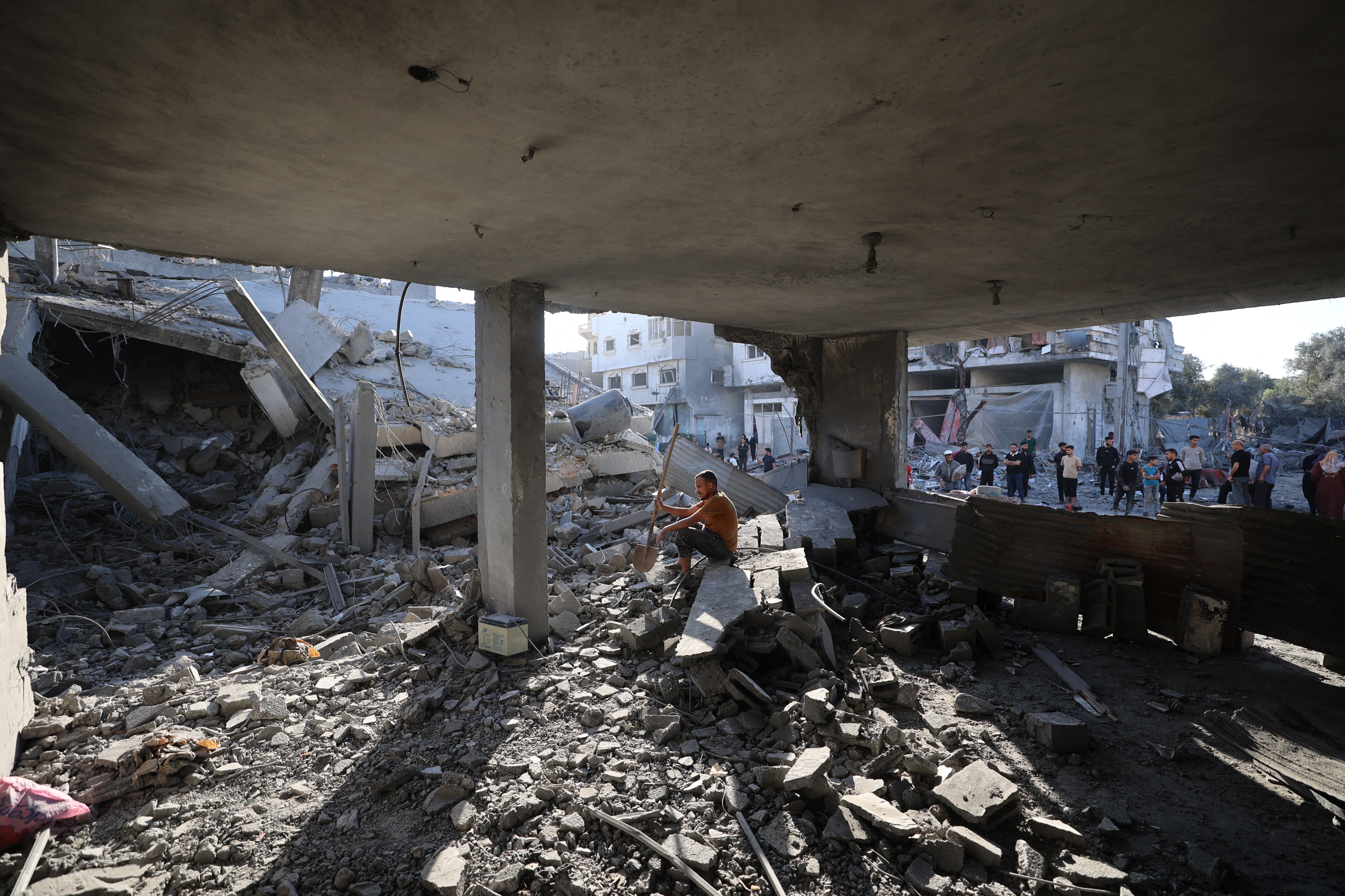 A Palestinian man sits amid debris at the site of an Israeli strike on a house whose residents were warned to evacuate before the attack, in Zawaida in the central Gaza Strip on June 5, 2026.