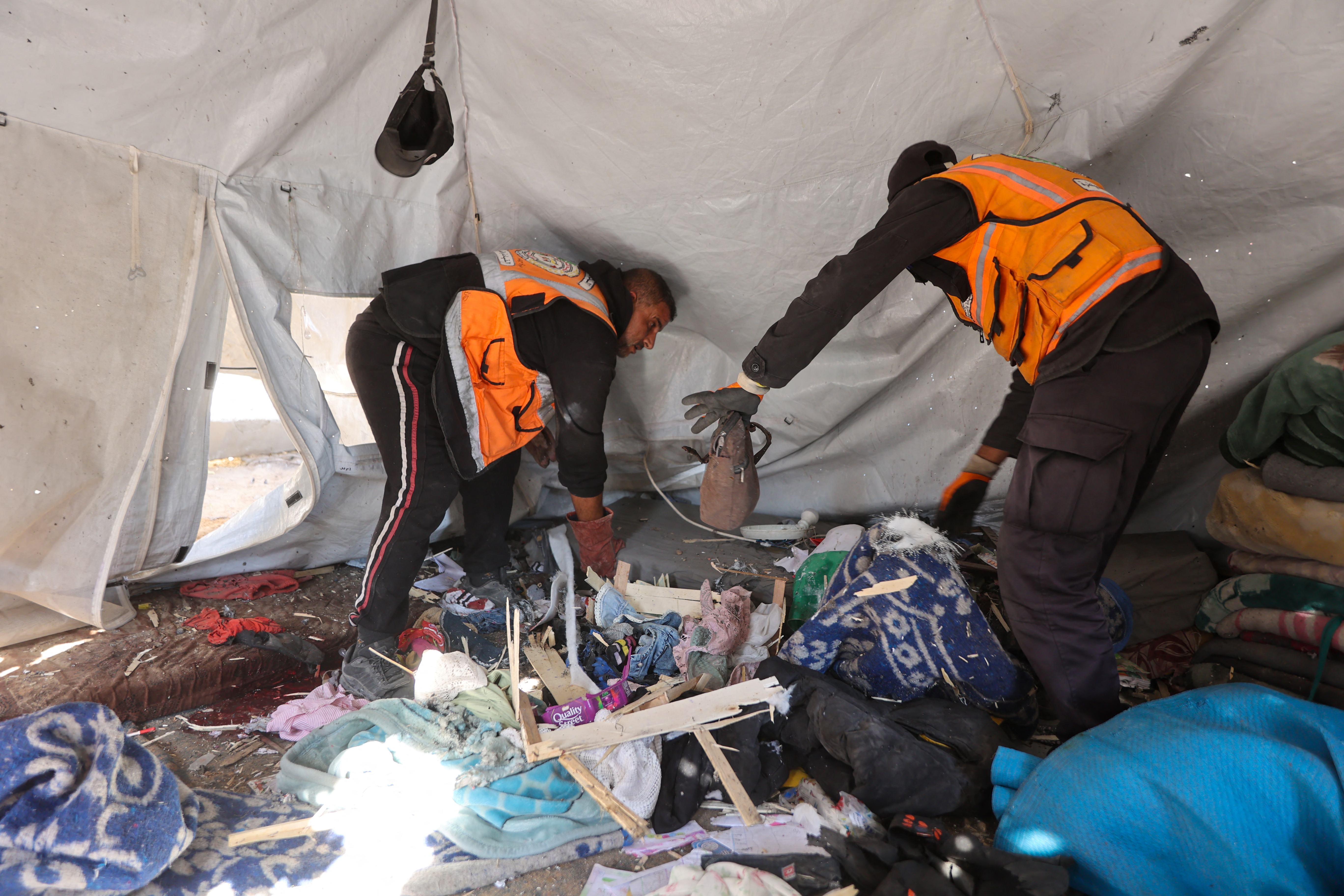 First responders inspect the inside of a tent that was sheltering displaced people after it was targeted in the al-Rimal neighbourhood of Gaza City on June 6, 2026.