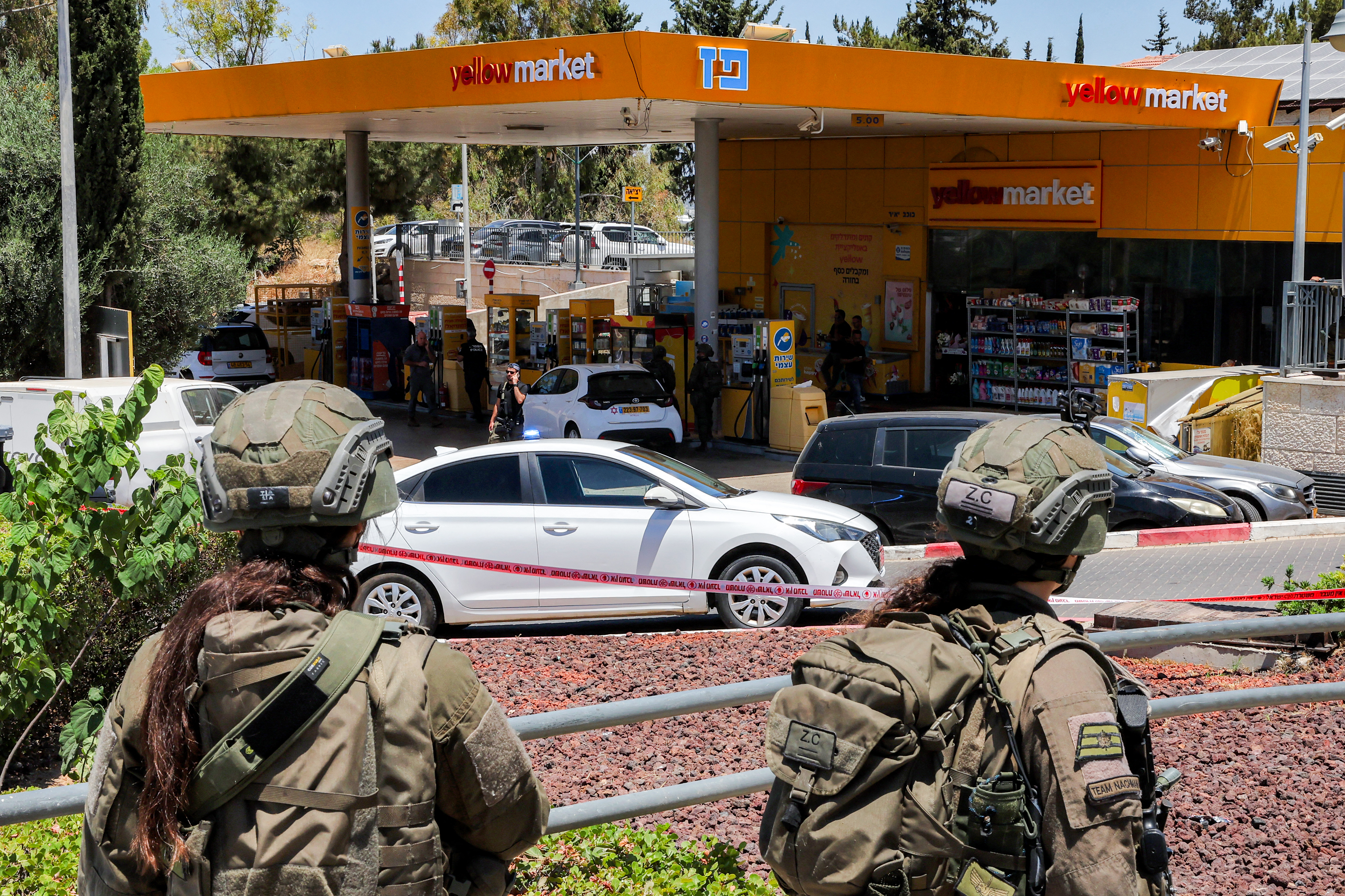 Israeli forces gather at a petrol station.