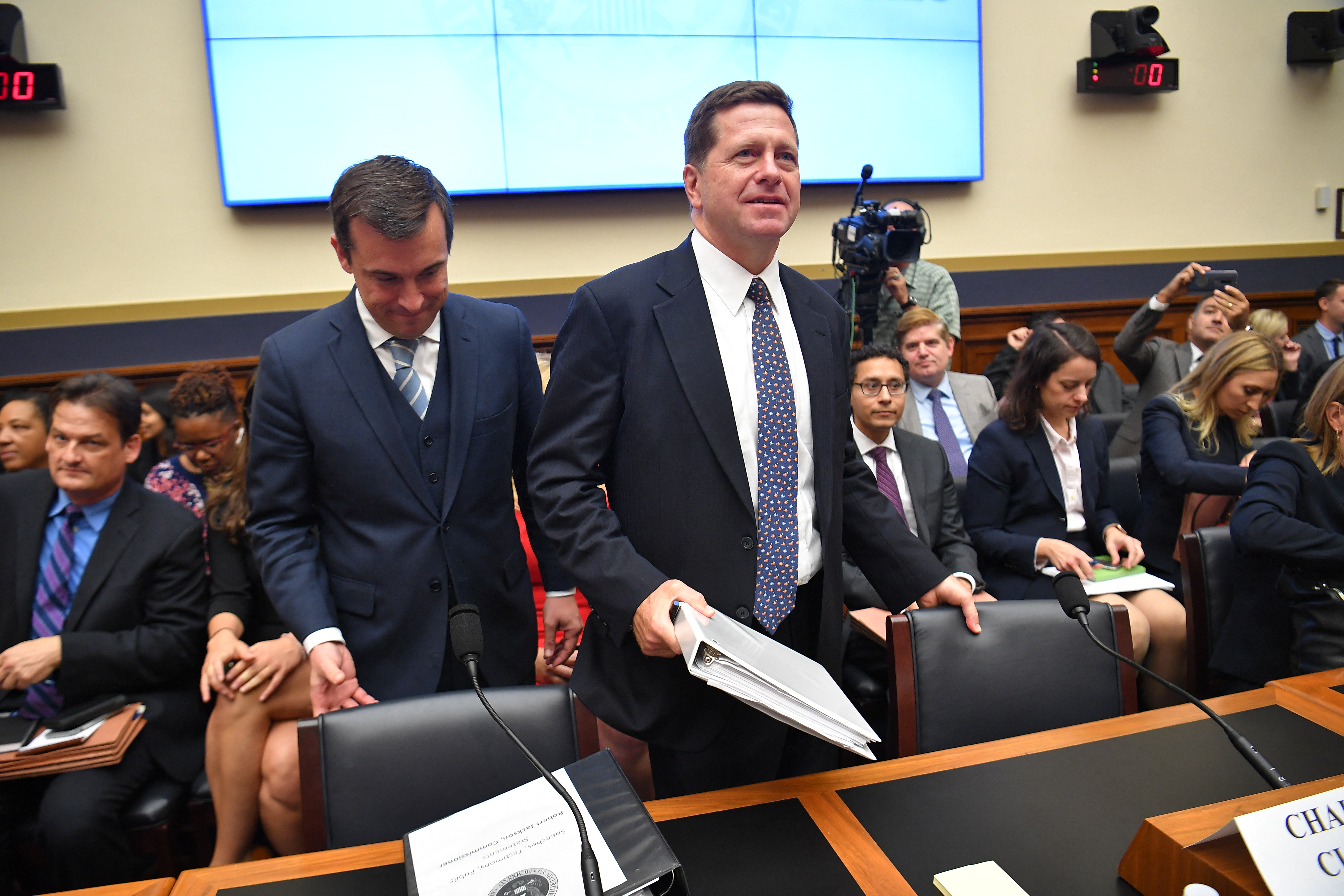 (FILES) SEC Commissioner Robert J. Jackson Jr. (L) and Securities and Exchange Commission Chairman Jay Clayton (R) arrive before they testify before the House Financial Services Committee on oversight of the Securities and Exchange Commission in the Rayburn House Office Building on Capitol Hill in Washington, DC on September 24, 2019.