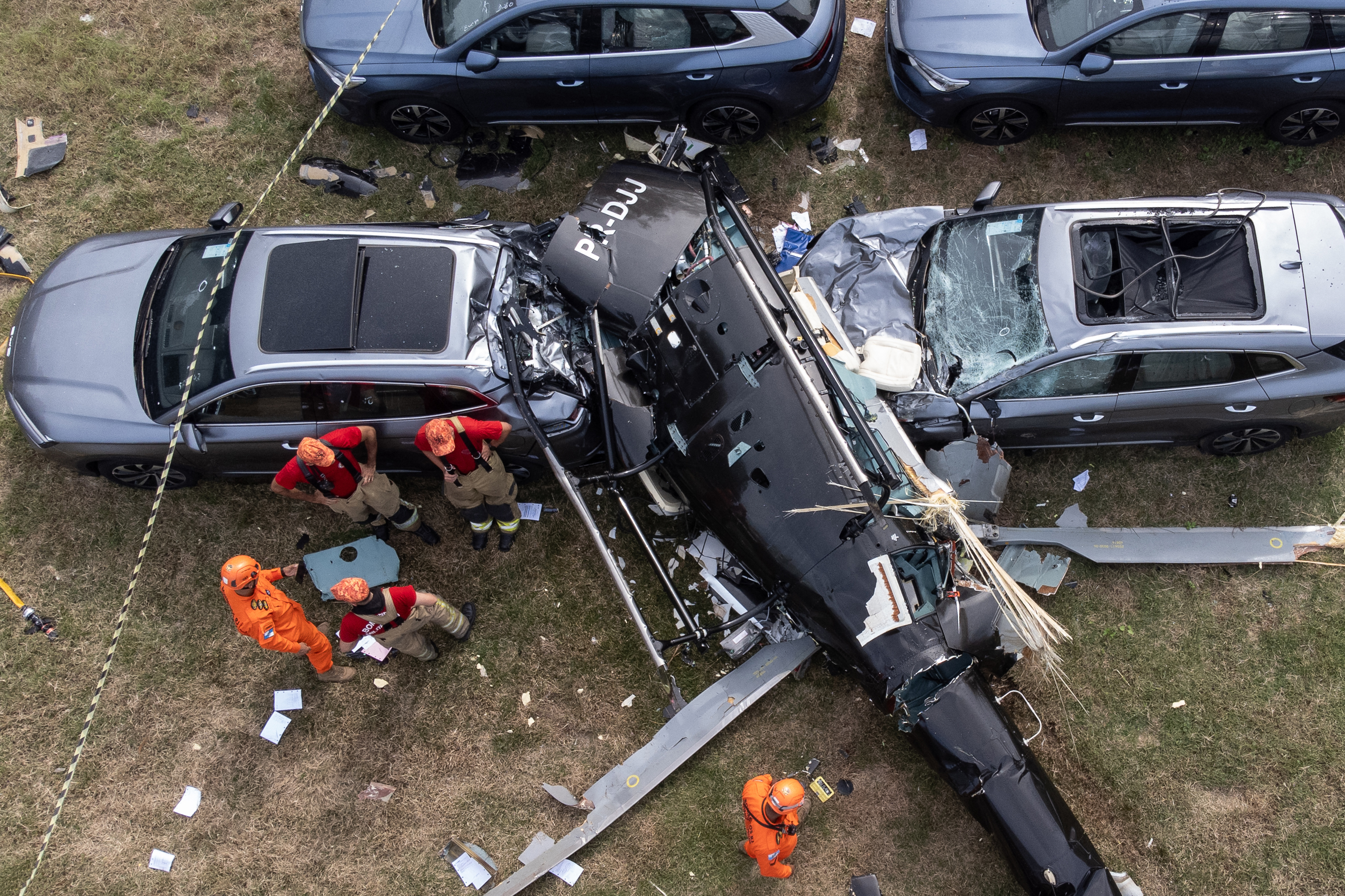 An aerial view shows firefighters working at the site of a helicopter crash in the Recreio dos Bandeirantes neighbourhood in Rio de Janeiro
