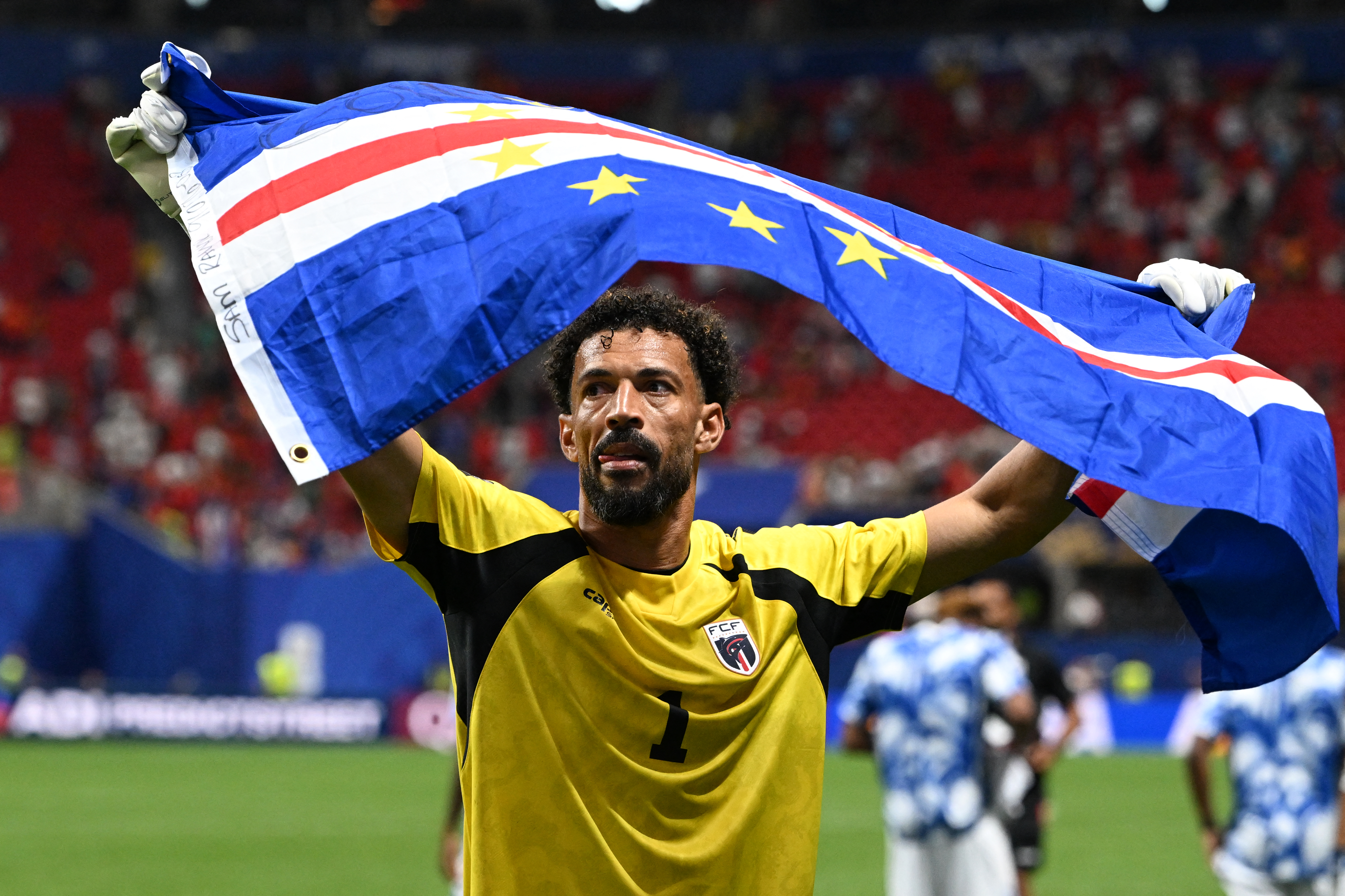 Cape Verde's goalkeeper #01 Vozinha celebrates with his national flag at the end of the 2026 World Cup Group H football match between Spain and Cape Verde at the Atlanta Stadium in Atlanta on June 15, 2026.