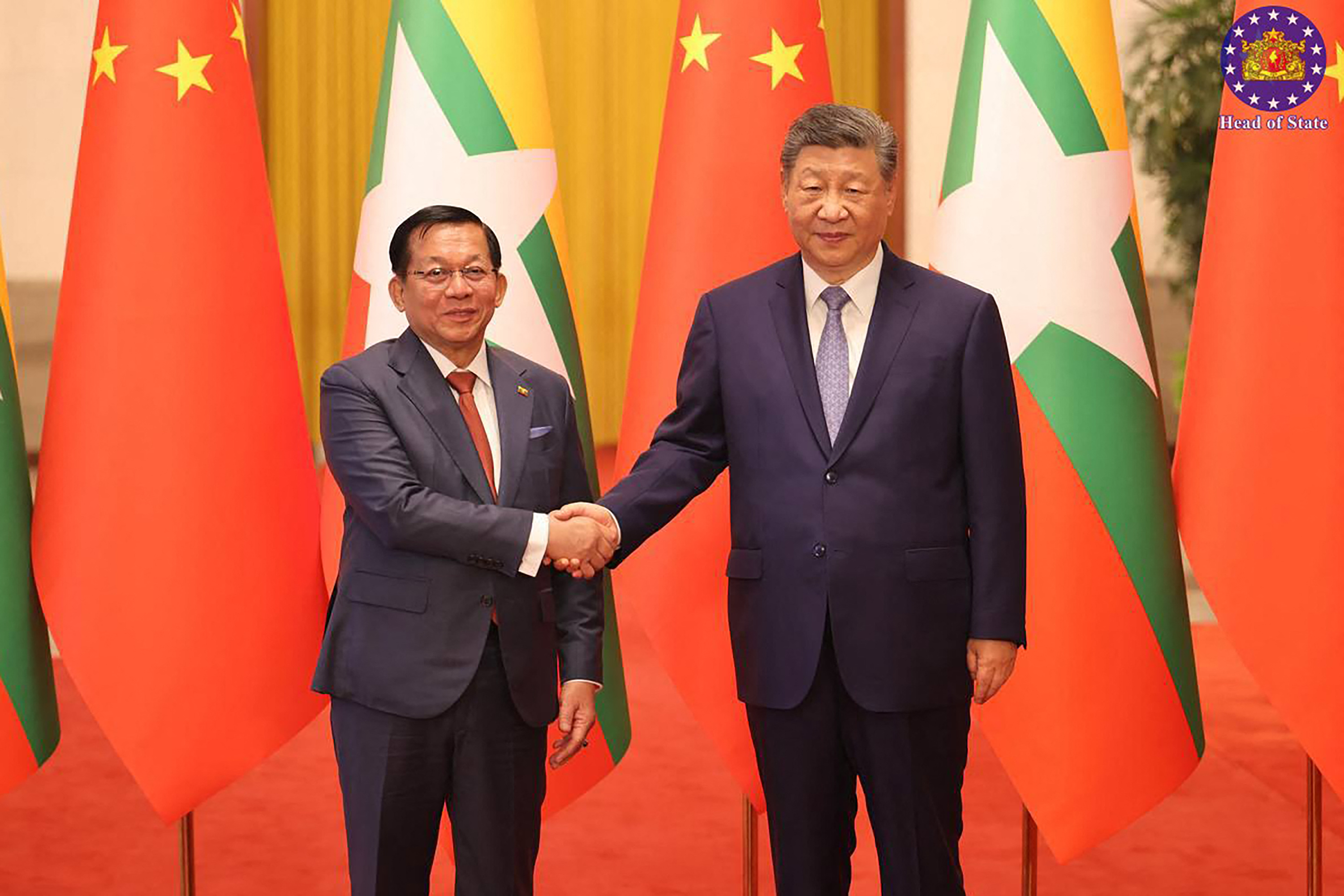 This handout picture taken and released on June 16, 2026 by Myanmar's Presidential Press and Information Bureau shows Myanmar's President Min Aung Hlaing (L) shaking hands with China's President Xi Jinping at the Great Hall of the People in Beijing. (Photo by Handout / Myanmar's Presidential Press and Information Bureau / AFP) / RESTRICTED TO EDITORIAL USE - MANDATORY CREDIT "AFP PHOTO / MYANMAR'S PRESIDENTIAL PRESS AND INFORMATION BUREAU" - HANDOUT - NO MARKETING NO ADVERTISING CAMPAIGNS - DISTRIBUTED AS A SERVICE TO CLIENTS