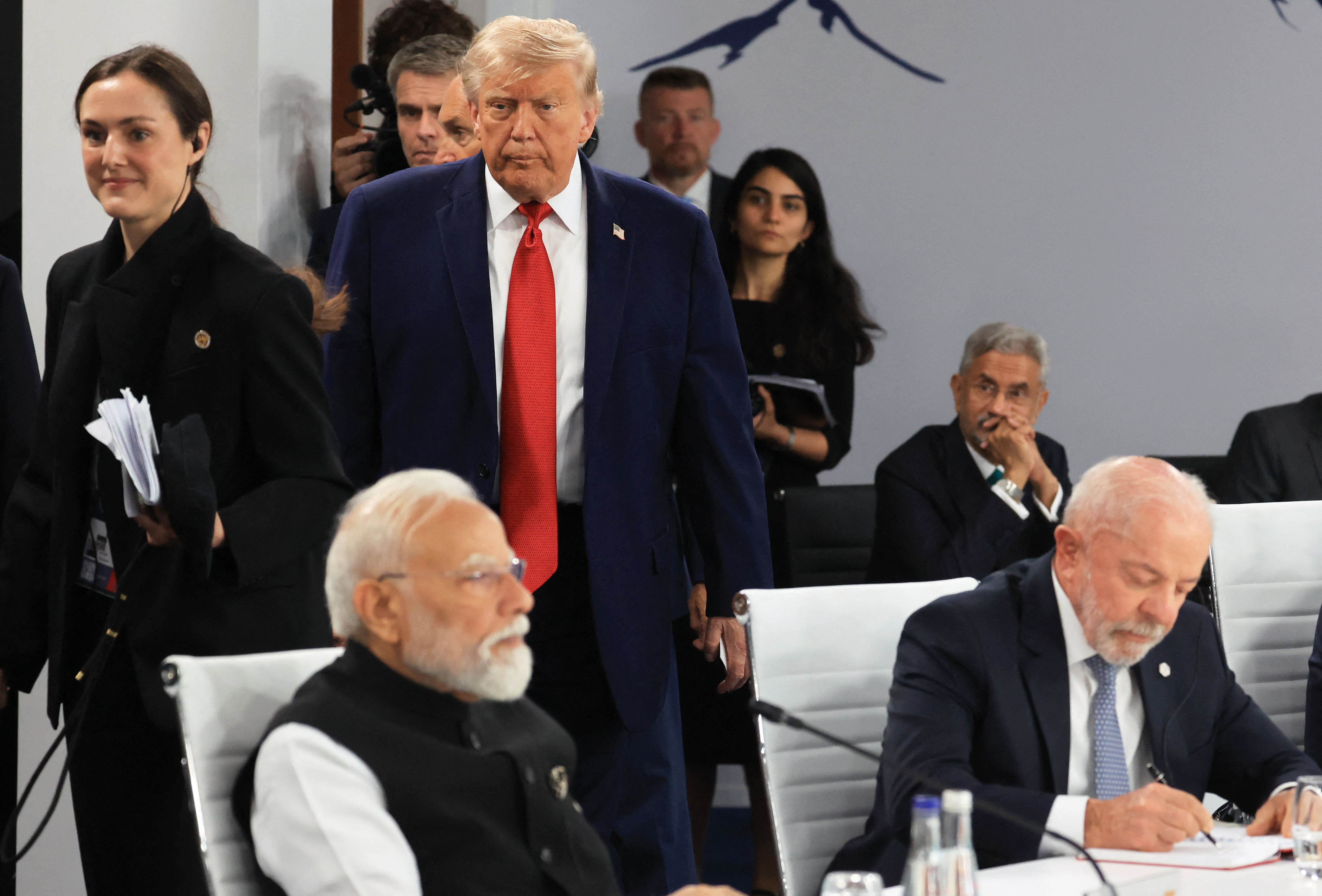 US President Donald Trump arrives as India's Prime Minister Narendra Modi (L) and Brazil's President Luiz Inacio Lula da Silva (R) attend a morning work meeting to “revive balanced, inclusive, and sustainable economic growth for the benefit of all” in the presence of the G7 countries, partner countries, the International Monetary Fund, and the OECD, as part of the G7 summit, in Evian, eastern France, on June 17, 2026.