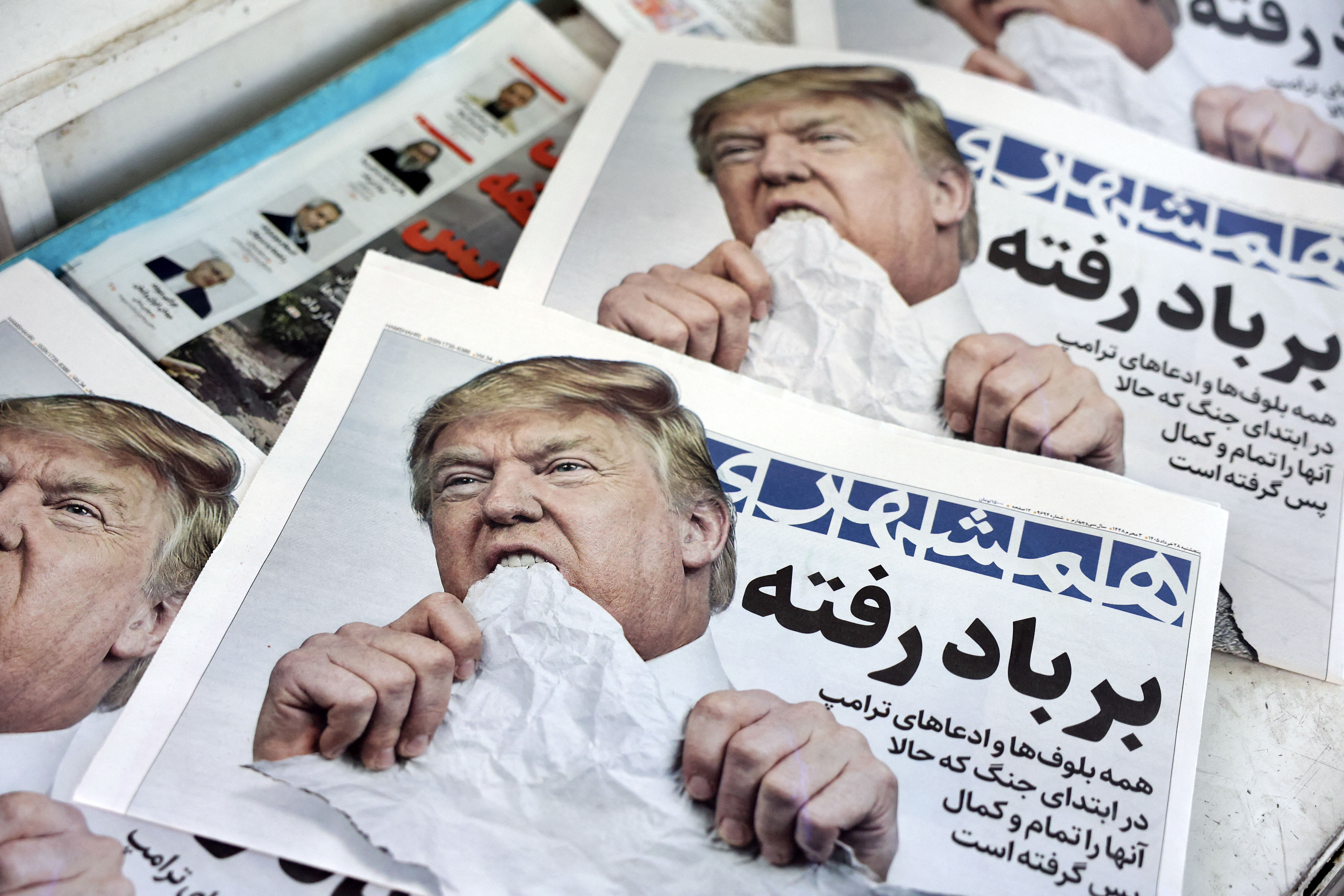 Copies of the Iranian daily newspaper Hamshahri with a satirical image of Trump