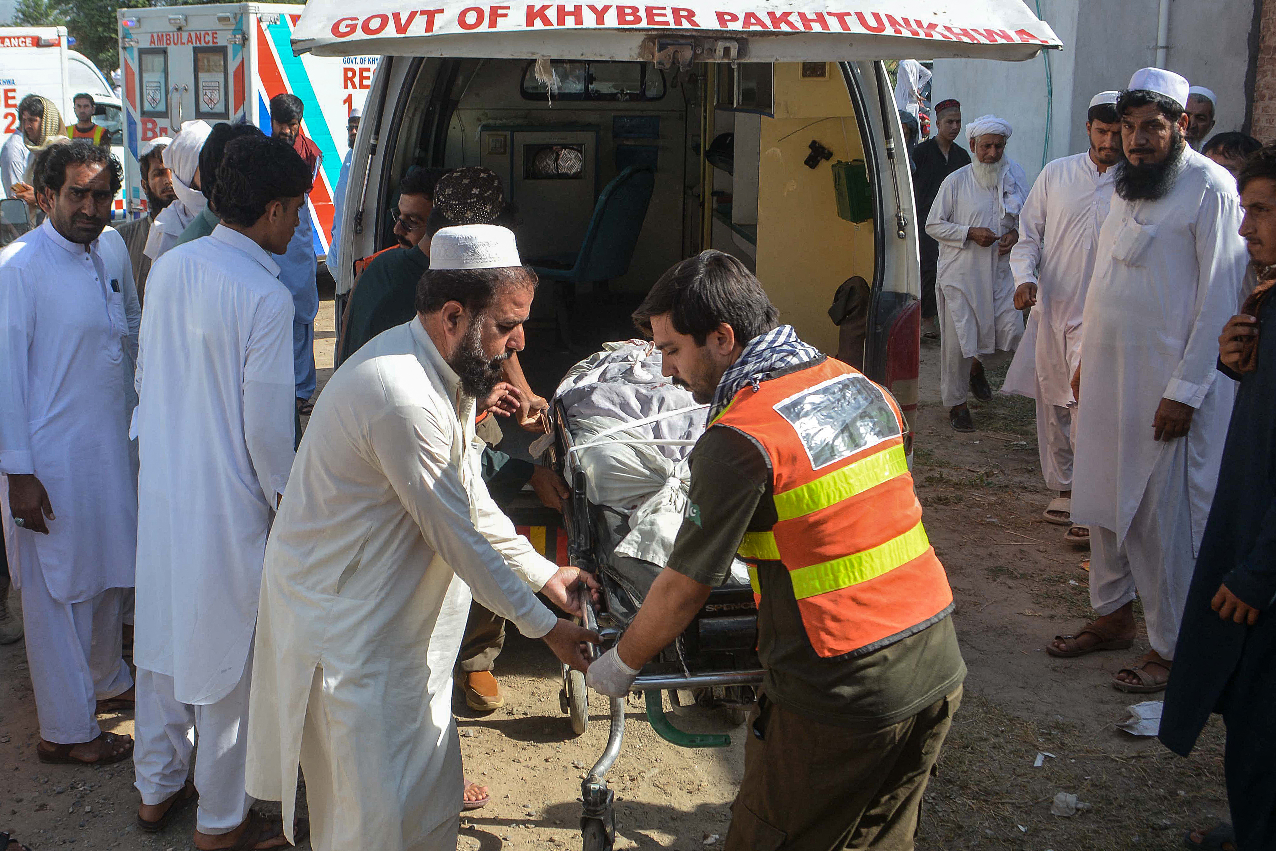 EDITORS NOTE: Graphic content / Volunteers transfer the body of a victim, killed in twin roadside blasts, to a hospital in Bannu on June 20, 2026.