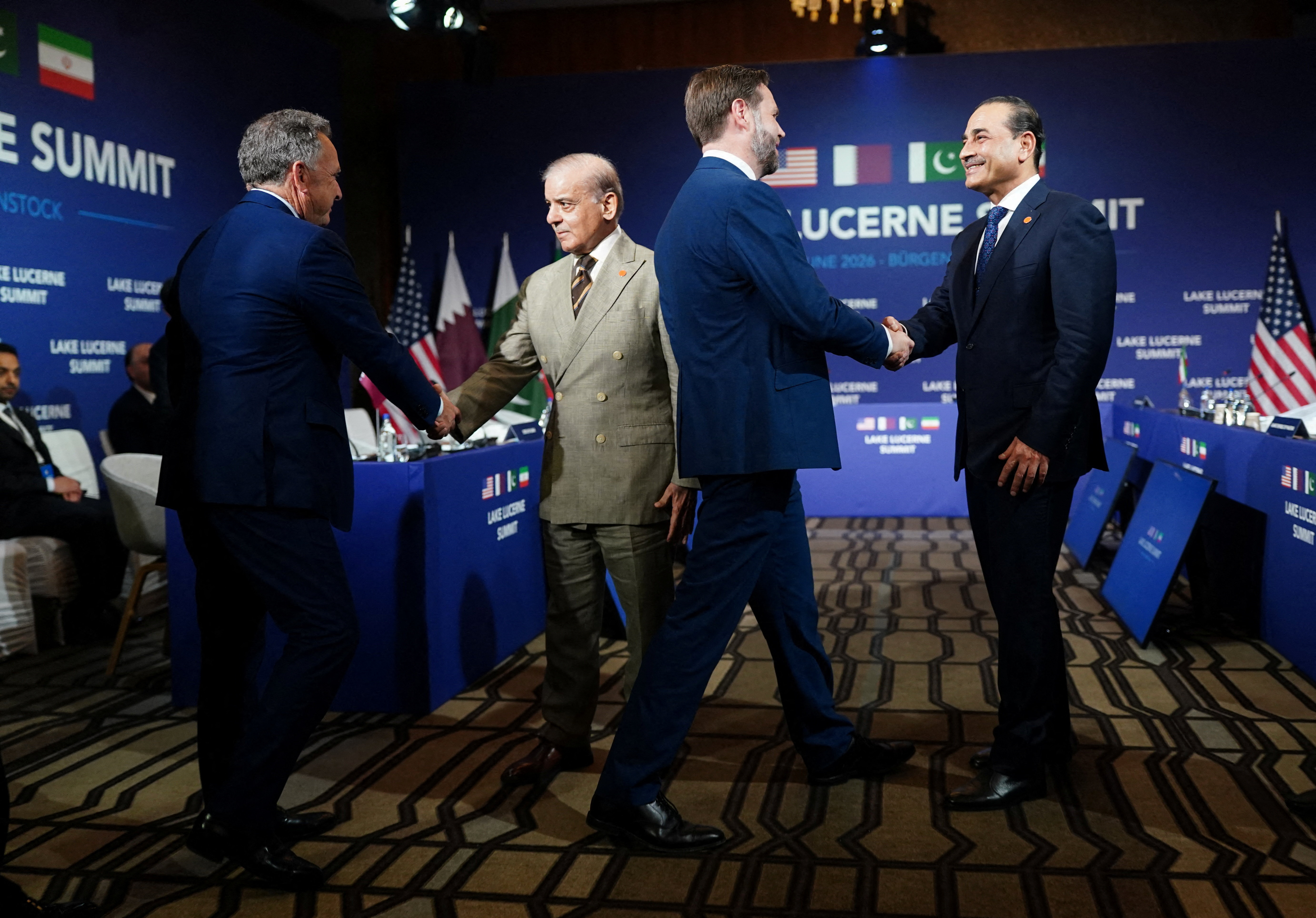 US Vice President JD Vance (2ndR), US President's special envoy Steve Witkoff (L), Pakistan's Prime Minister Shehbaz Sharif (2ndL) and Pakistan's Chief of Army Staff Field Marshal Asim Munir shake hands ahead of a quadrilateral meeting between the United States, Iran, Pakistan and Qatar at the Burgenstock luxury hotel complex overlooking Lake Lucerne, Switzerland, on June 21, 2026, as part of high-level talks aimed at advancing a deal to end the Middle East conflict.
