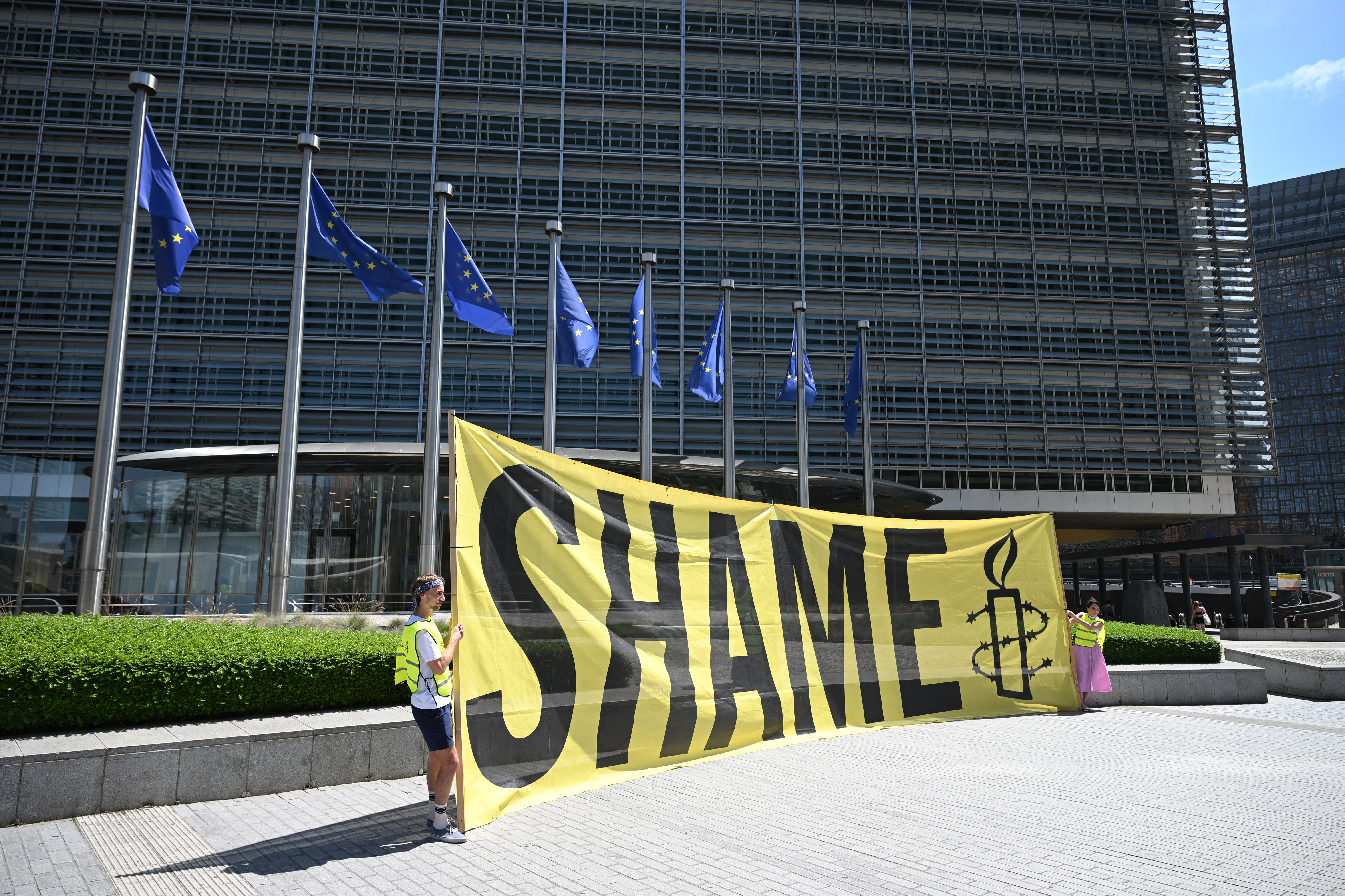Amnesty International activists hold a banner reading "Shame" in front the EU Commission headquarters to protest against a meeting with a Taliban delegation in Brussels on June 23, 2026.