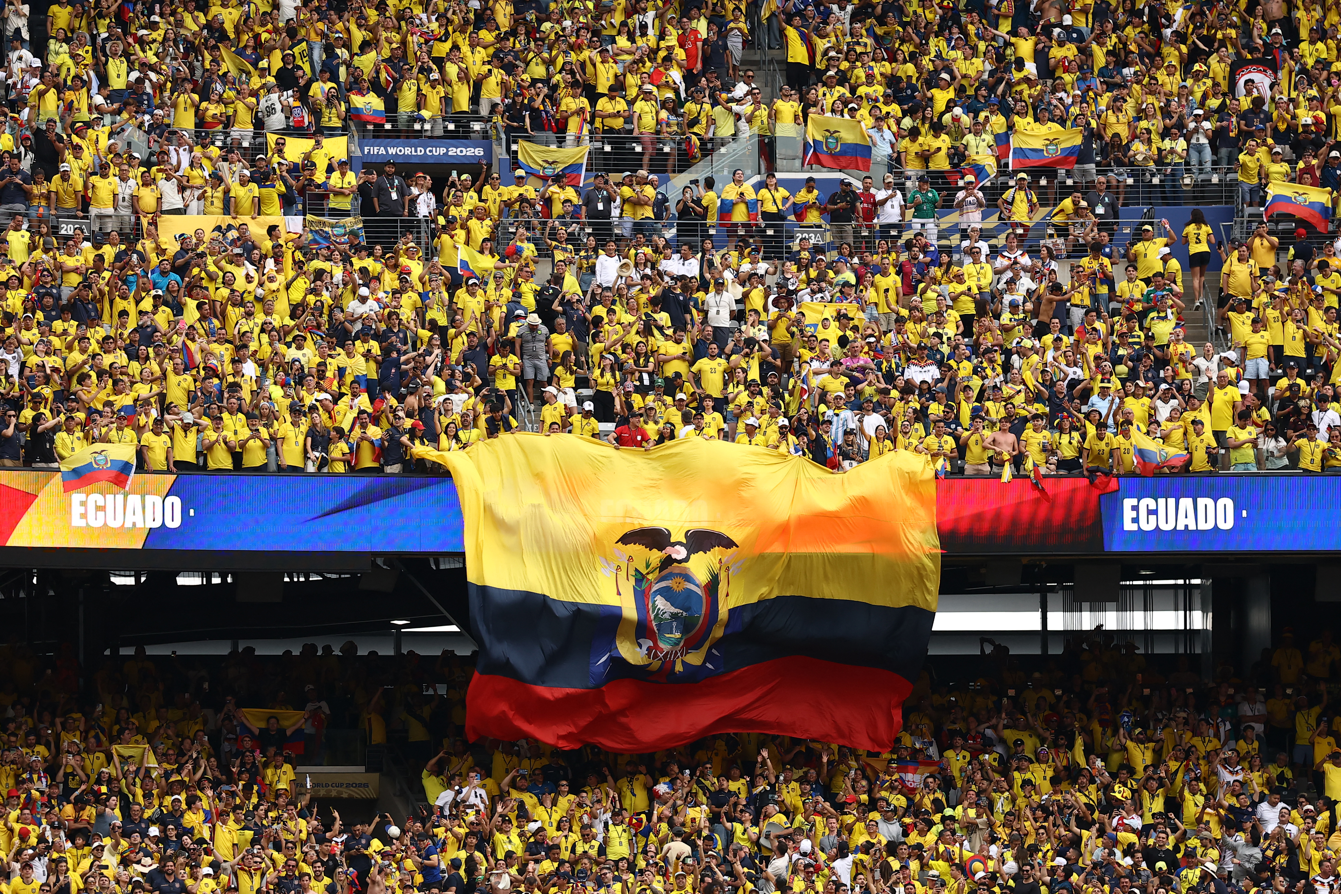 Ecuadorian fans display a giant national flag after winning the 2026 World Cup Group E football match between Ecuador and Germany at the New York/New Jersey Stadium in East Rutherford on June 25, 2026. (Photo by CHARLY TRIBALLEAU / AFP)