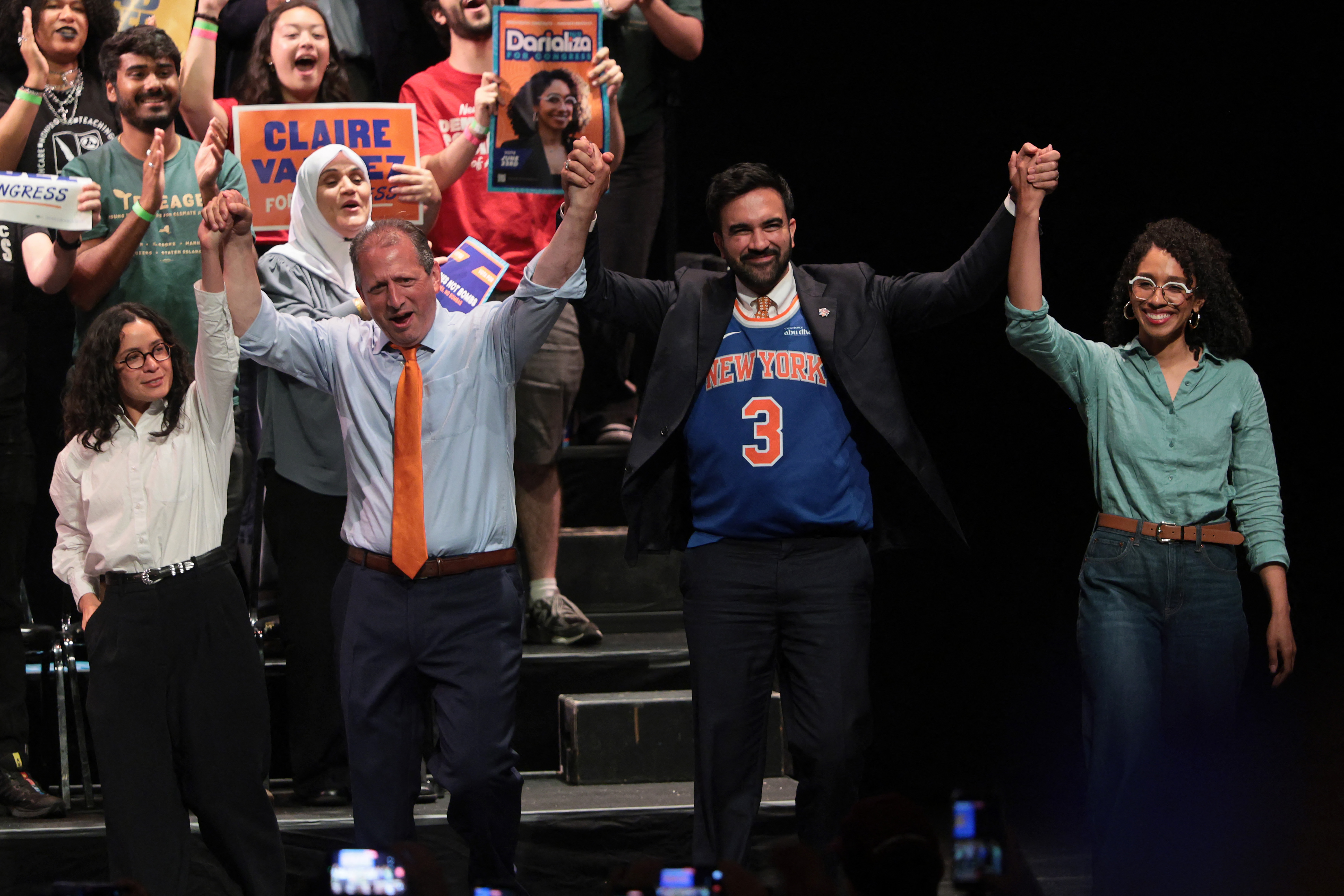 NEW YORK, NEW YORK - JUNE 18: Congressional candidate Claire Valdez, Congressional candidate Brad Lander, Mayor Zohran Mamdani, and Congressional candidate Darializa Avila Chevalier raise their hands during a Get Out the Vote (GOTV) rally at King's Theater on June 18, 2026 in New York City. Sen. Bernie Sanders (I-VT) joined Mayor Zohran Mamdani ahead of next week's primary, and the start of early voting on Saturday, as the pair campaigned for Brad Lander, Claire Valdez and Darializa Avila Chevalier, who are challenging incumbents in Democratic primary contests. Michael M. Santiago/Getty Images/AFP (Photo by Michael M. Santiago / GETTY IMAGES NORTH AMERICA / Getty Images via AFP)