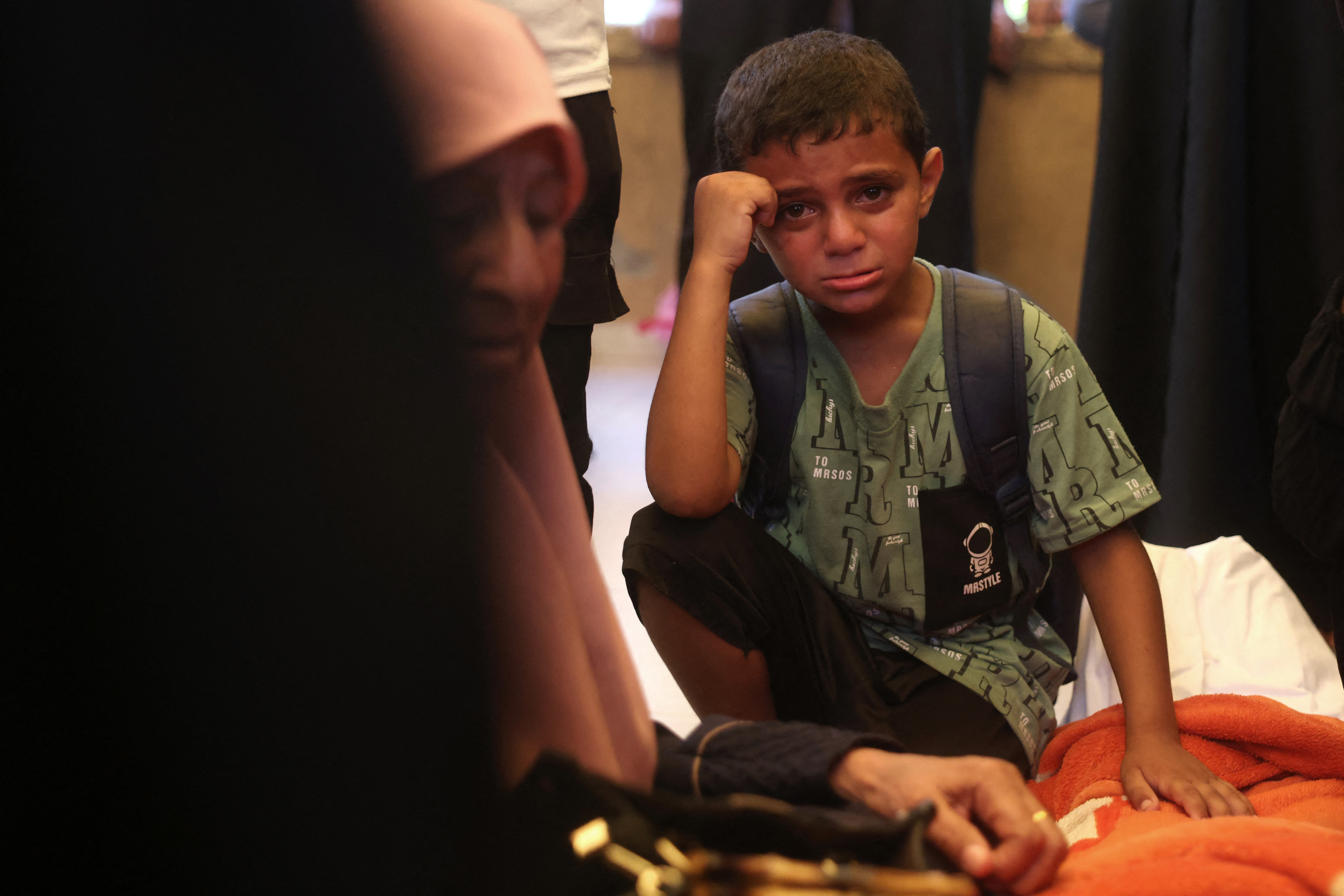 A boy reacts as mourners attend the funeral of 15-year-old Islam Moussa and her brother Abdallah, who were both reportedly killed in an Israeli airstrike, in Khan Yunis in the souhthern Gaza Strip on June 27, 2026.