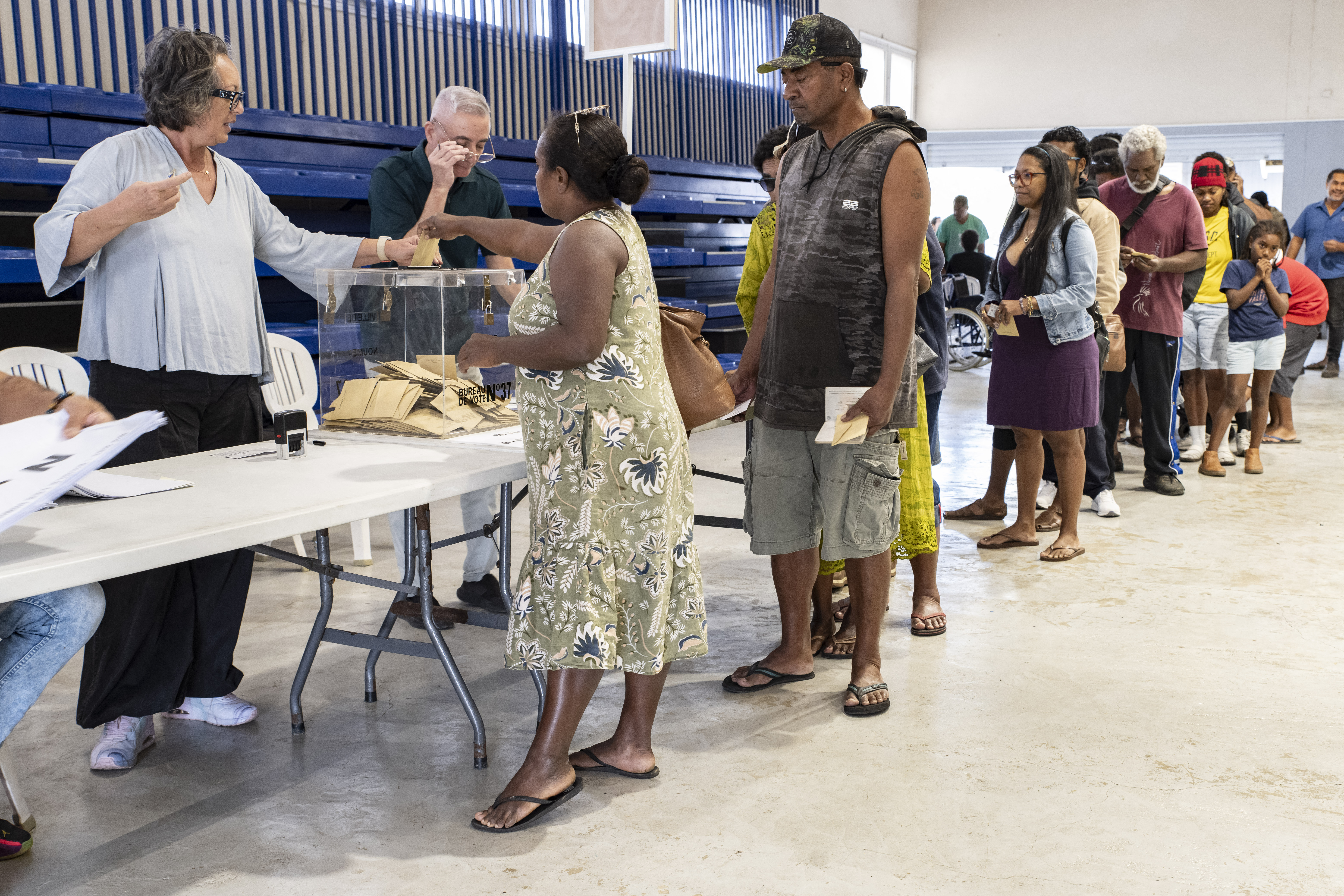 People vote at a polling station.