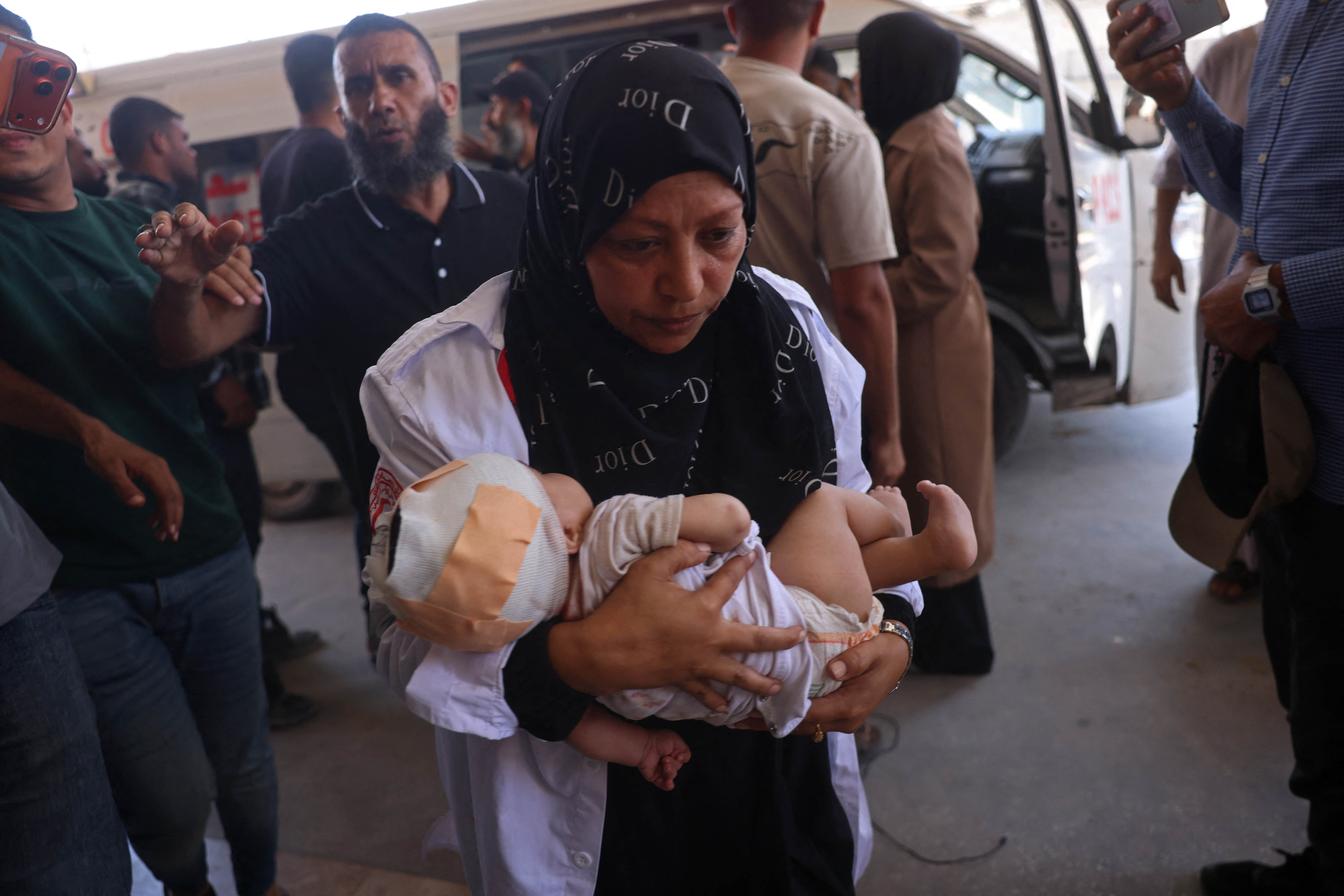 A Palestinian nurse carries an injured child at Nasser Hospital in Khan Yunis in the southern Gaza Strip, following a reported Israeli strike on a displacement camp in Al-Mawasi, on June 27, 2026. [AFP]