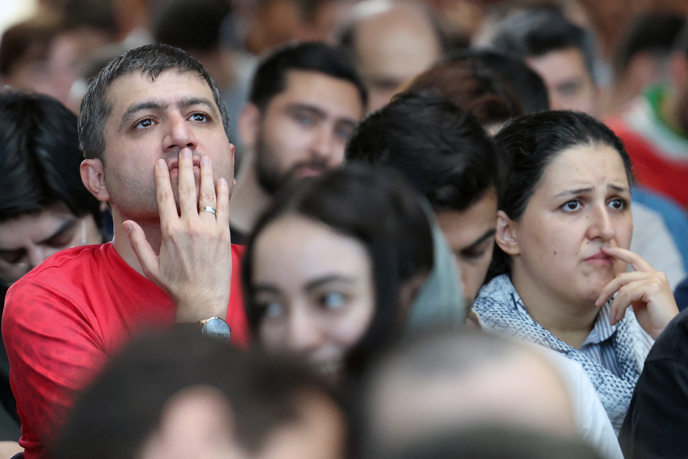 Iranians react as they watch the FIFA World Cup 2026 Group G football match between Egypt and Iran in Tehran on June 27, 2026.