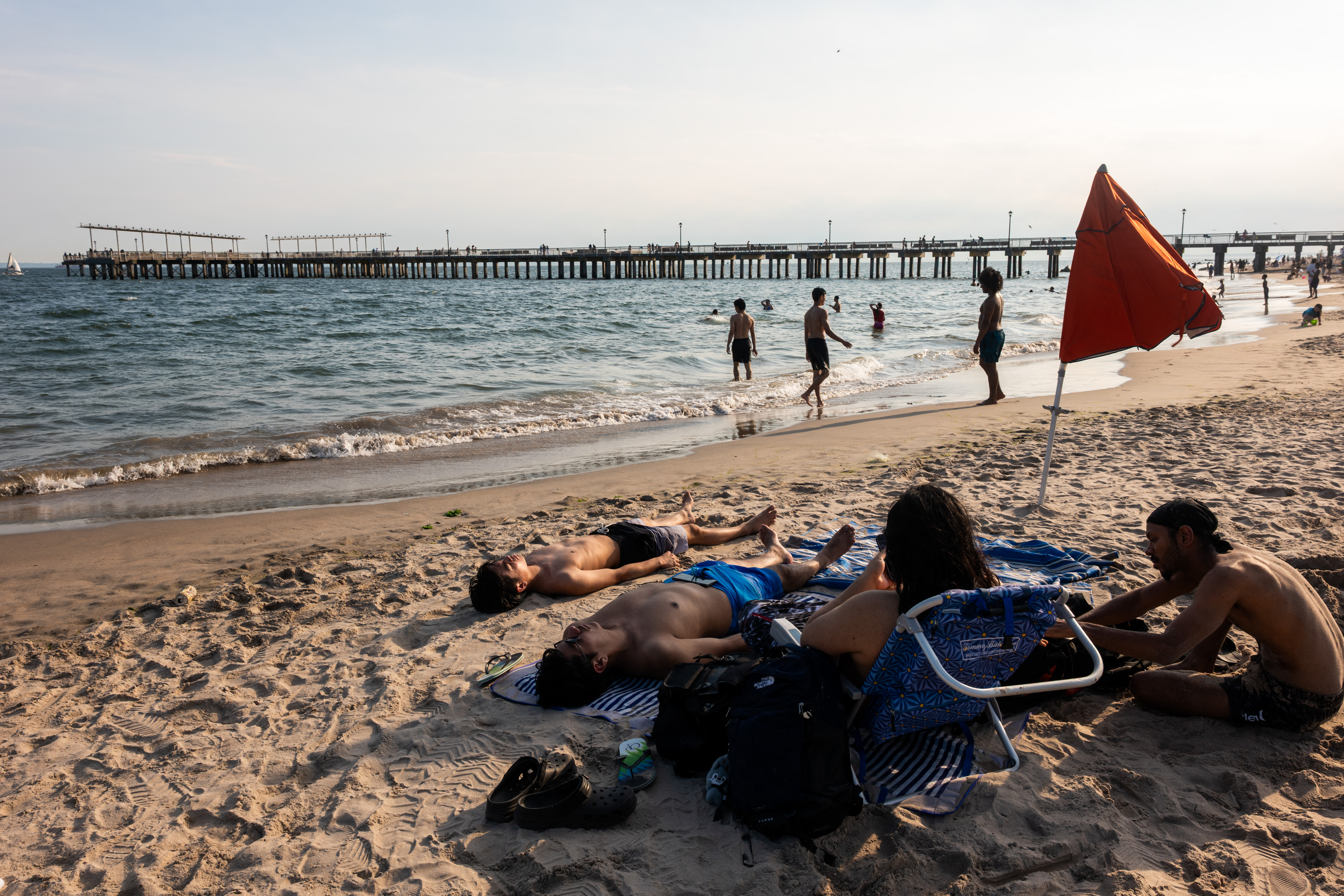NEW YORK CITY - JUNE 29: People cool off at Coney Island beach on June 29, 2026 in the Brooklyn borough of New York City. A heat wave is forecast for much of the East Coast this week, with temperatures in the city expected to reach near 100 degrees, prompting Mayor Zohran Mamdani to activate a heat emergency plan that includes hundreds of cooling centers and intensified outreach and support for the vulnerable. Spencer Platt/Getty Images/AFP (Photo by SPENCER PLATT / GETTY IMAGES NORTH AMERICA / Getty Images via AFP)