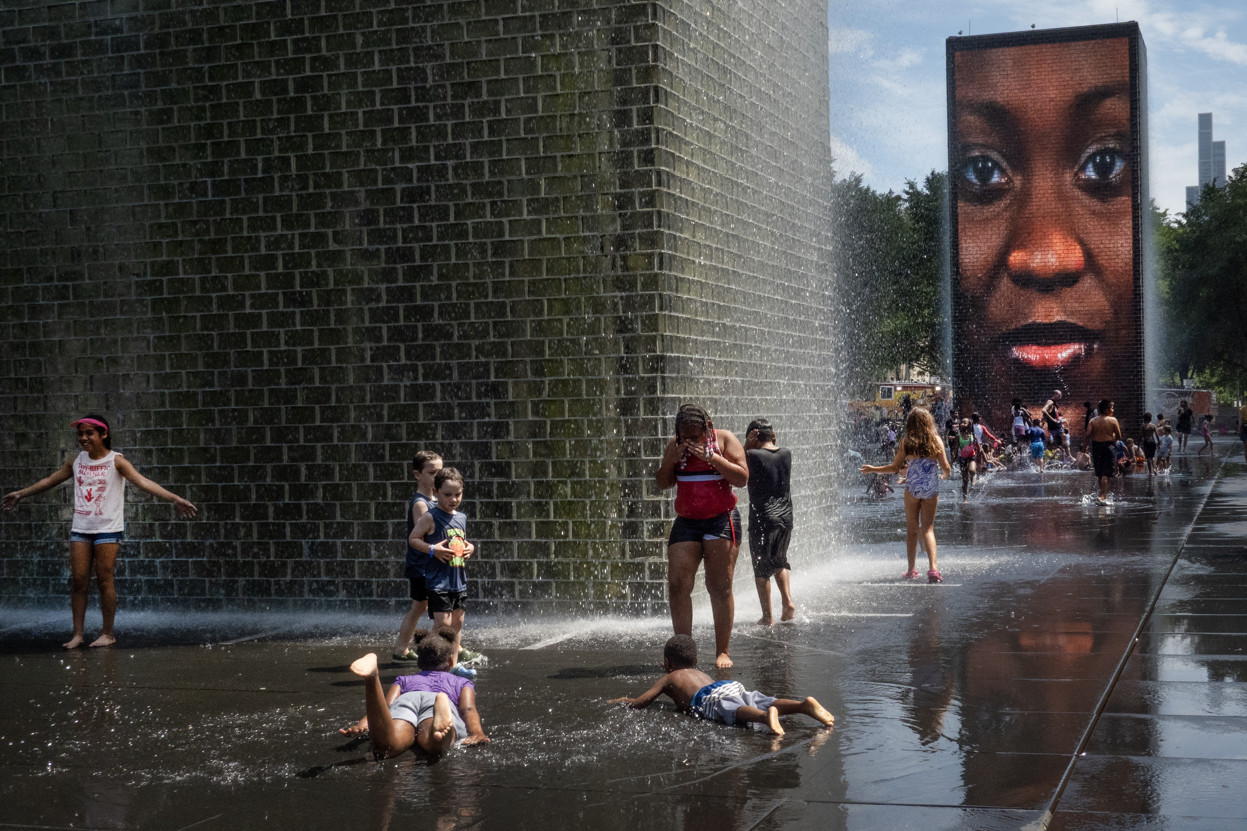CHICAGO, ILLINOIS - JUNE 29: People cool off at Crown Fountain in Millennium Park as temperatures topped 90 degrees on June 29, 2026 in Chicago, Illinois. High humidity and temperatures in the nineties with heat indices above 100 degrees are expected to remain in the city through the Independence Day holiday. Scott Olson/Getty Images/AFP (Photo by SCOTT OLSON / GETTY IMAGES NORTH AMERICA / Getty Images via AFP)