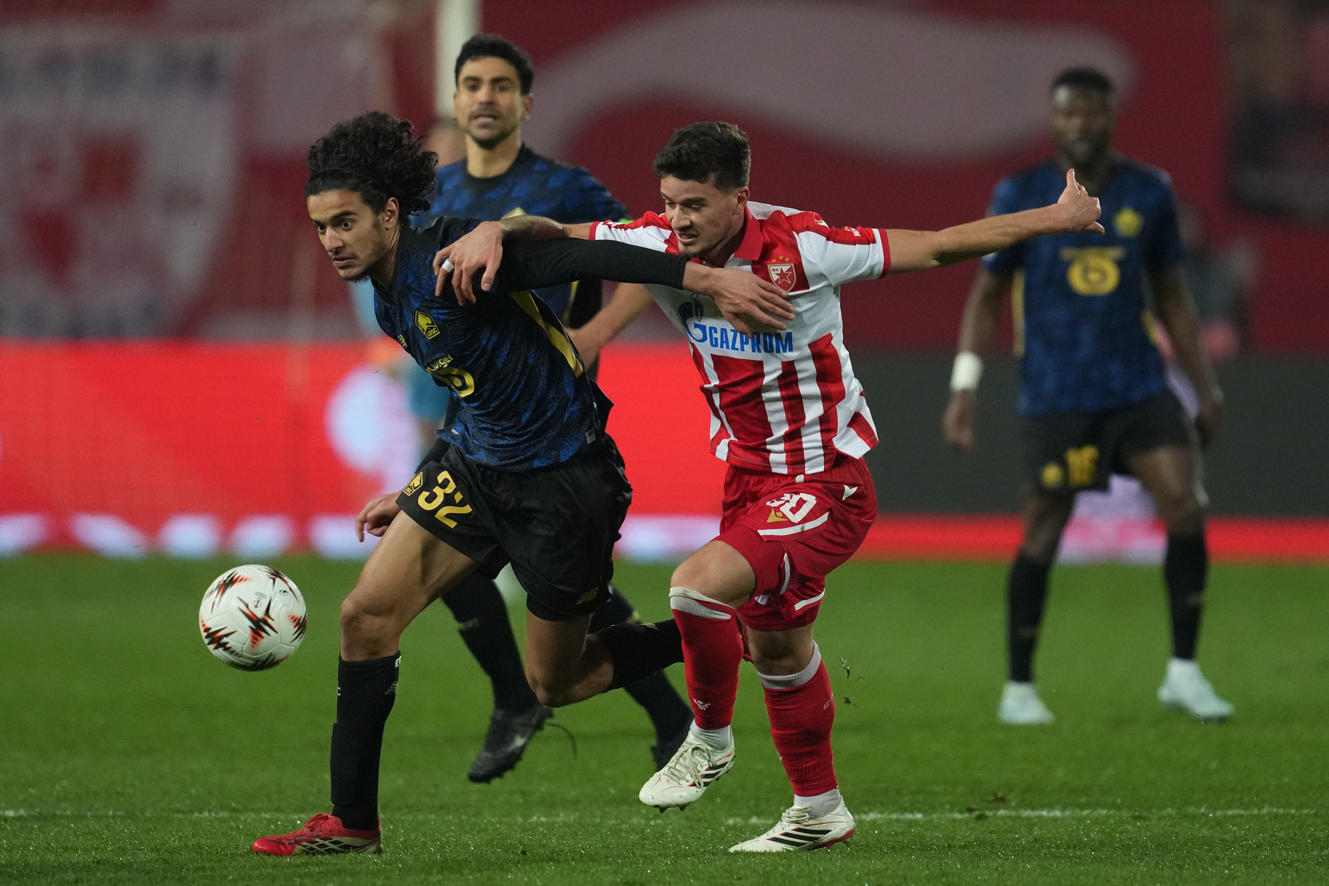 Red Star's Tomas Haendel , right, and Lille's Ayyoub Bouaddi fight for the ball suring the second leg of the Europa League playoff soccer match between Red Star and Lille in Belgrade, Serbia, Thursday, Feb. 26, 2026. (AP Photo/Darko Vojinovic)