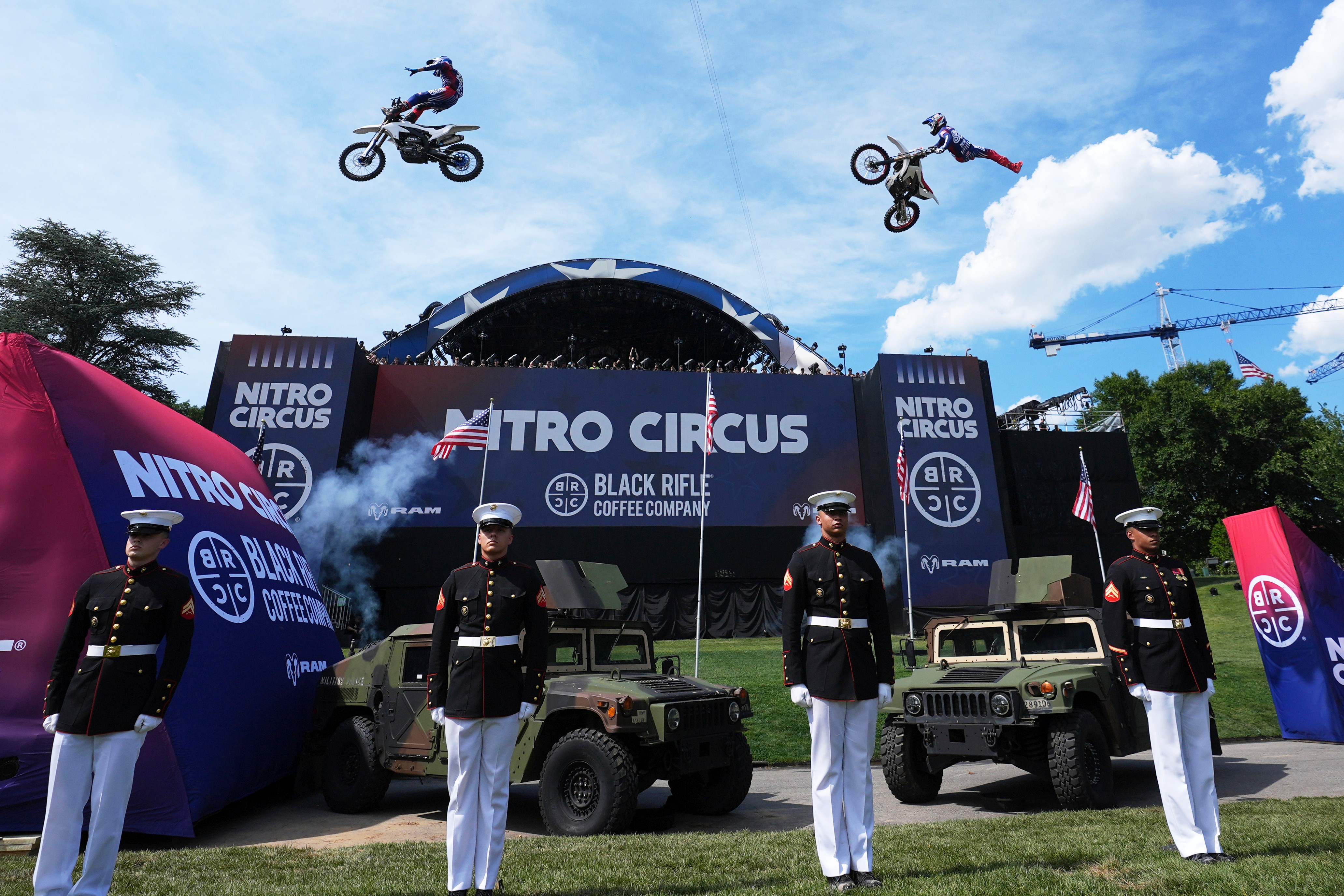 Motorsports athletes and stunt performers do a motorcycle jump ahead of the UFC Freedom 250 fights on the South Lawn of the White House, Saturday, June 13, 2026, in Washington. (AP Photo/Alex Brandon, Pool)